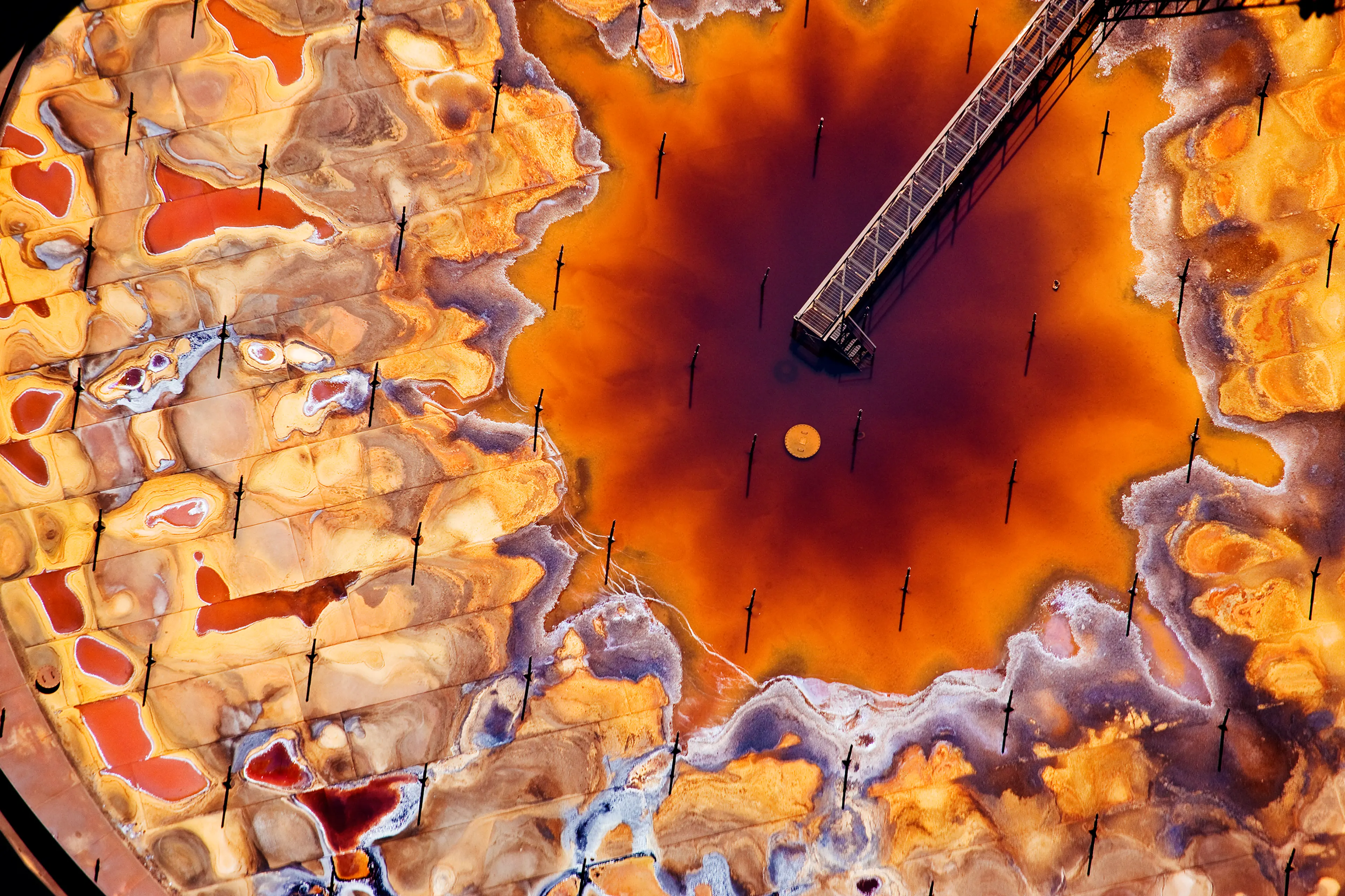 Fort McMurray, Canada The first step in the oil sands process after extraction is ‘upgrading’, in which particulate matter is removed from the bitumen and its viscosity reduced so that refineries can process it. This is a photograph of the top of a petro