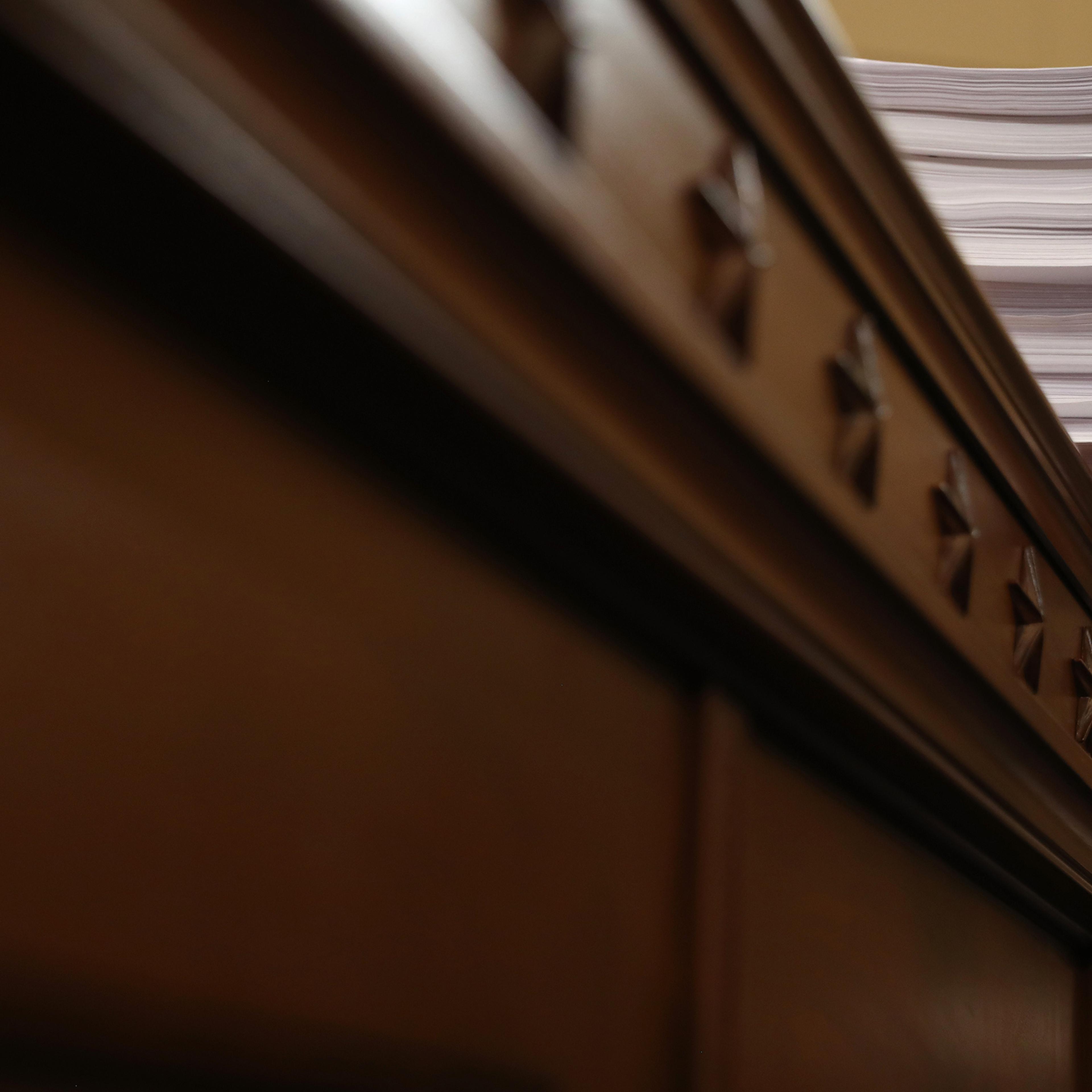 A stack of transcrips of depositions are shown during the third day of open hearings in the impeachment inquiry against President Donald Trump, Nov. 19, 2019.