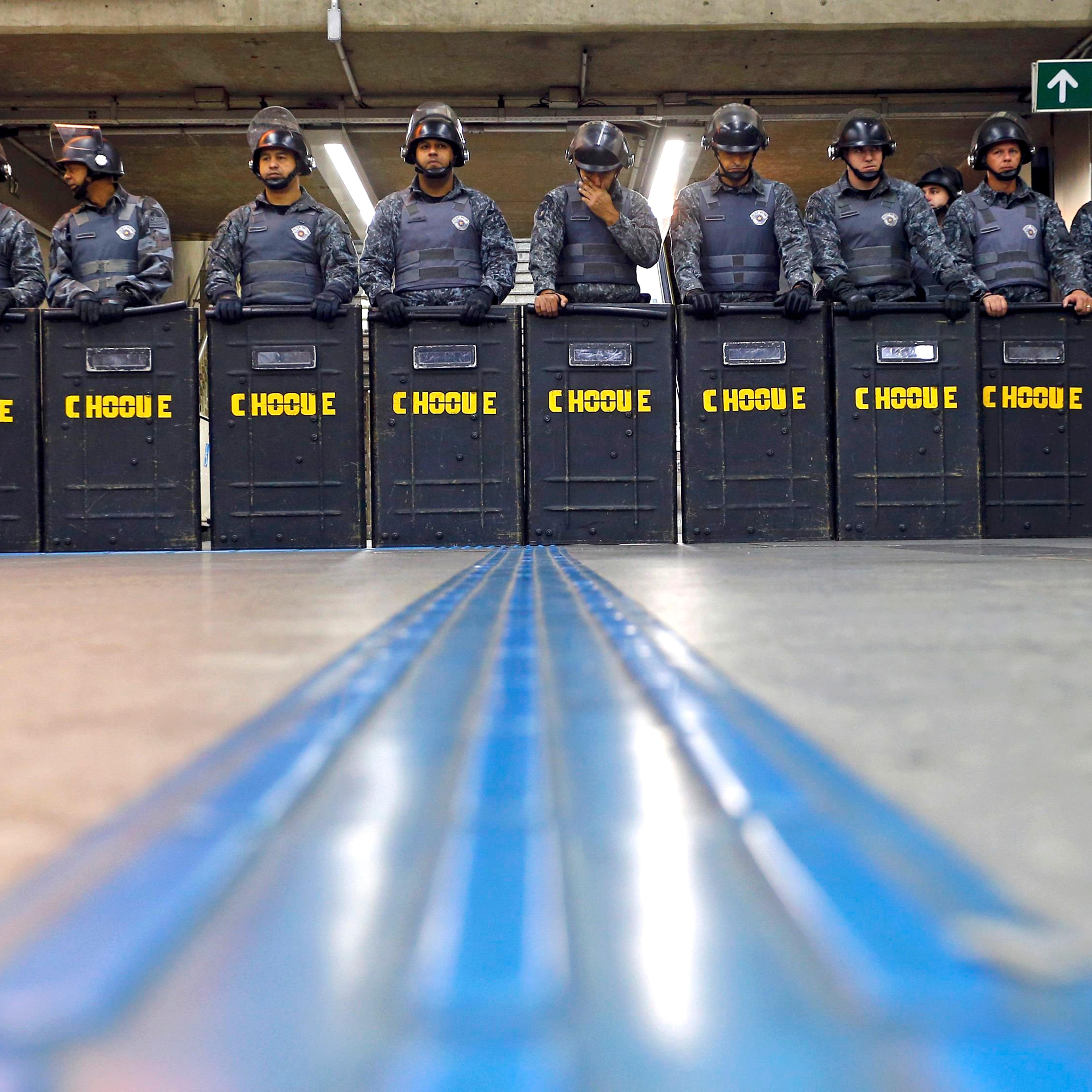 Policemen in riot gear stand inside Ana Rosa subway station during the fifth day of metro worker's protest in Sao Paulo on June 9, 2014.