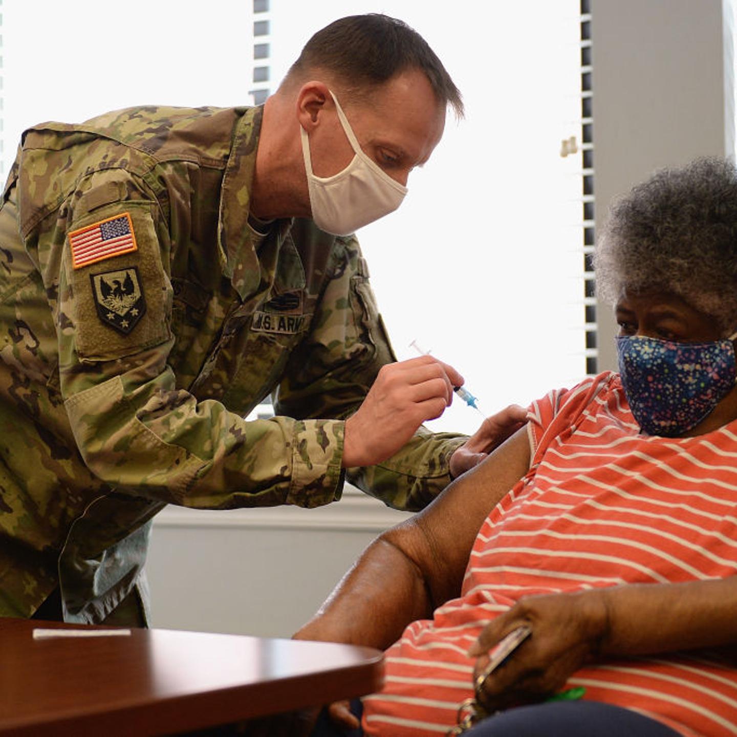 A member of the Missouri Army National Guard administers a Covid-19 vaccine on February 11, 2021 at a senior living facility in St Louis.