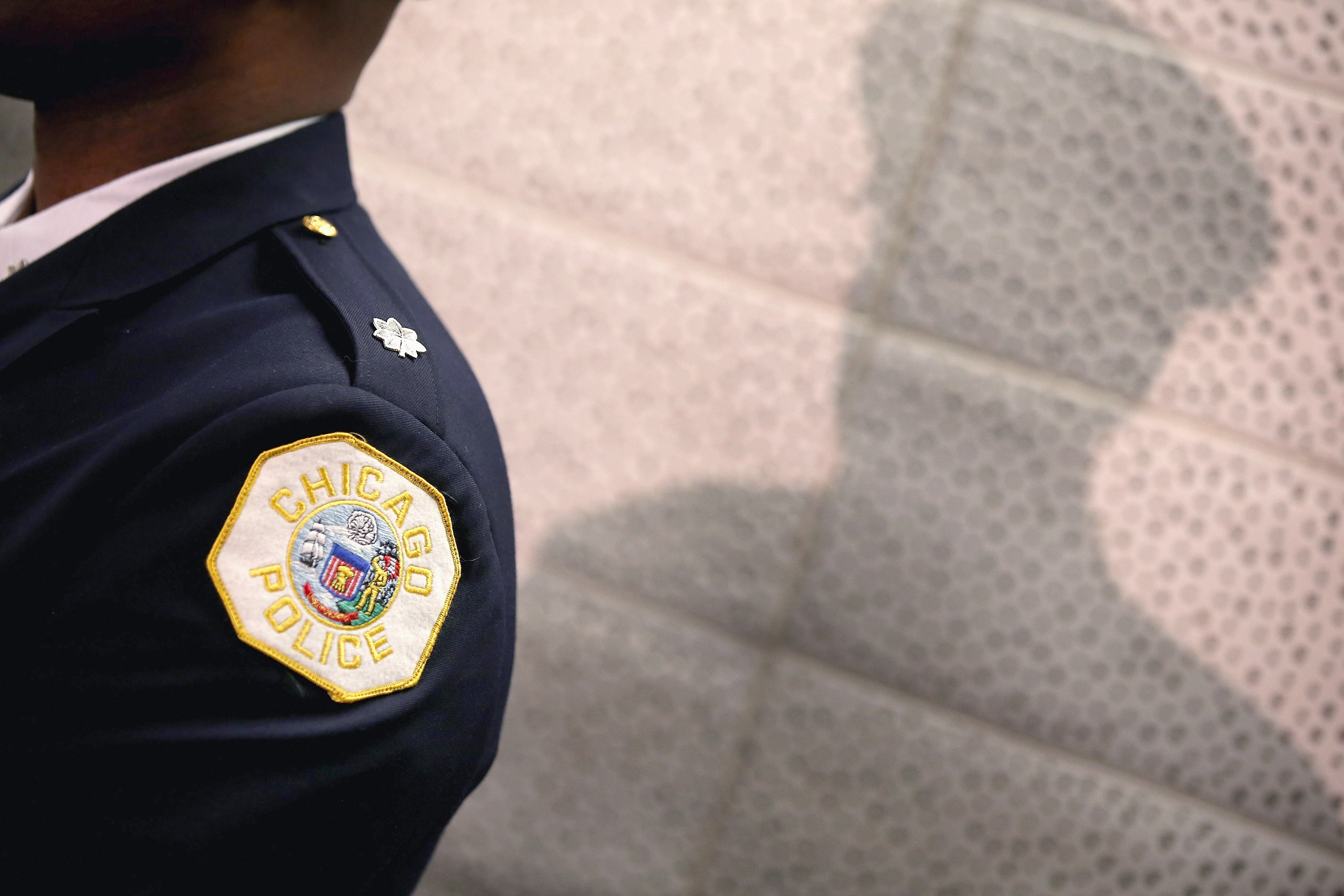 CHICAGO, IL - JANUARY 31: A Chicago police officer listens as Mayor Rahm Emanuel discusses a plan to reassign 200 police officers from administrative duties back to patrol duties during a press conference on January 31, 2013 in Chicago, Illinois. Chicago