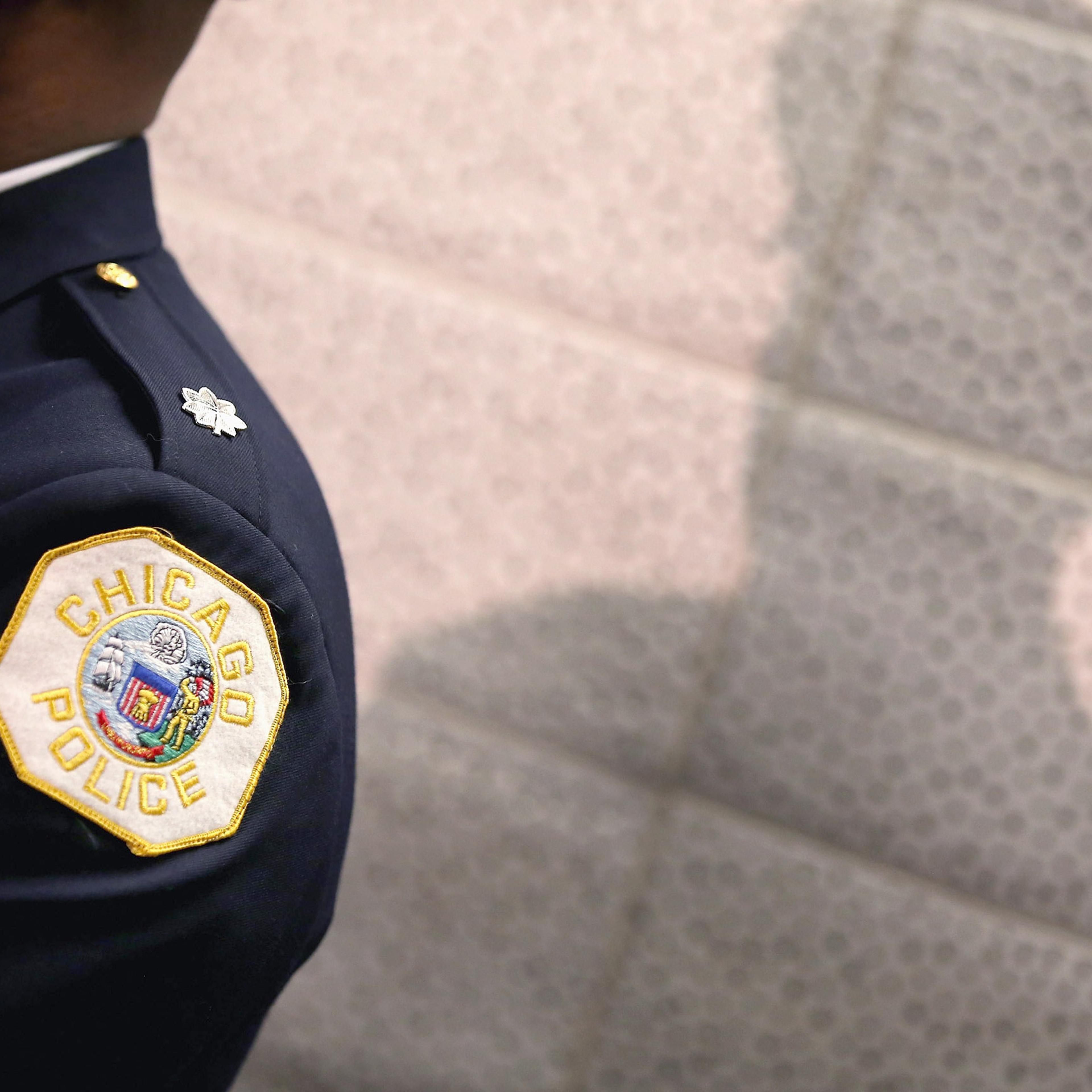 CHICAGO, IL - JANUARY 31: A Chicago police officer listens as Mayor Rahm Emanuel discusses a plan to reassign 200 police officers from administrative duties back to patrol duties during a press conference on January 31, 2013 in Chicago, Illinois. Chicago