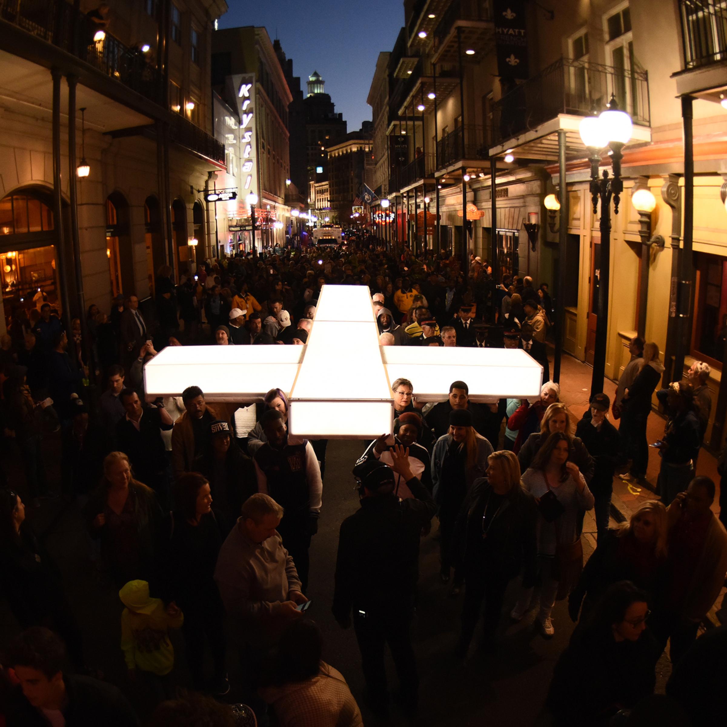 The cross being carried through the streets of New Orleans in "The Passion", a two-hour epic musical Live event from New Orleans on Palm Sunday, March 20, 2016.