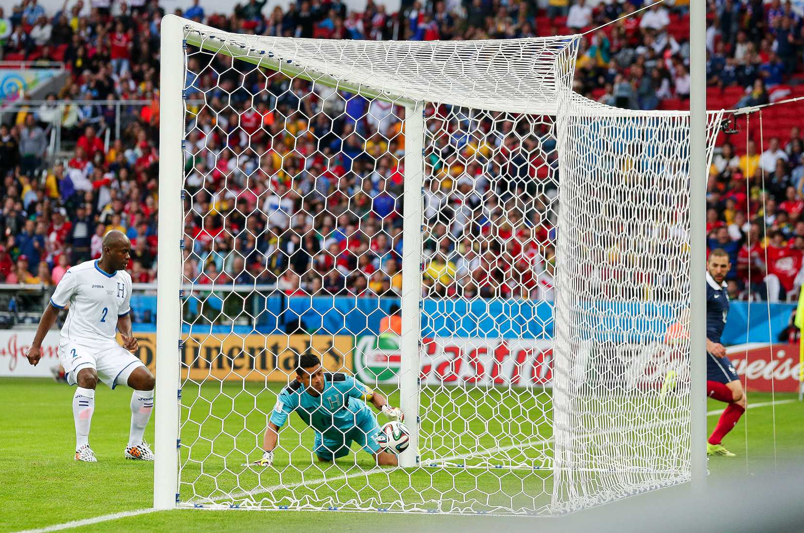 Honduras' goalkeeper Noel Valladares bundles a shot from France's Karim Benzema, far right, into his net for an own goal during the group E World Cup soccer match between France and Honduras at the Estadio Beira-Rio in Porto Alegre, Brazil, Sunday, June 15, 2014.
