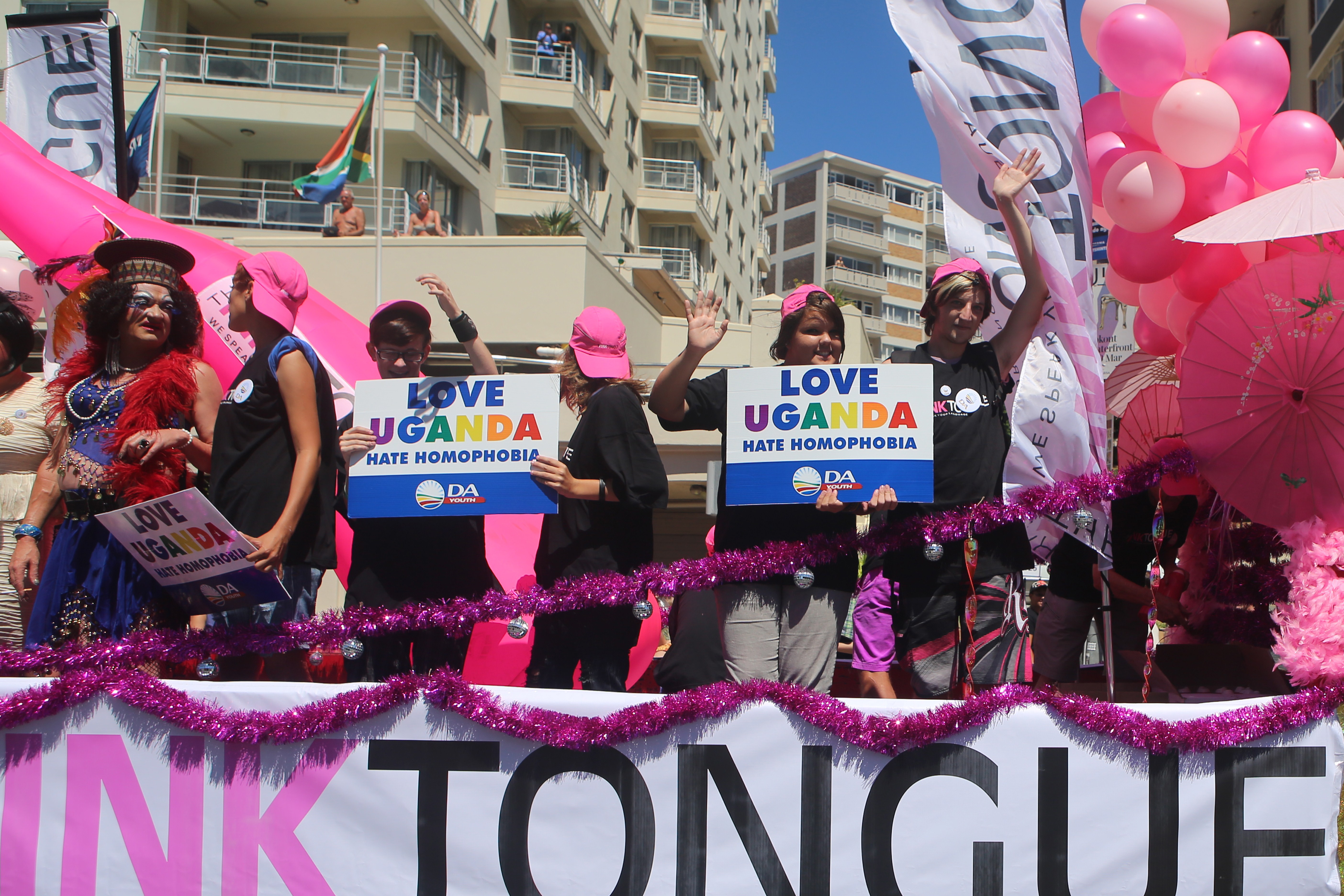 People stand on a float holding signs saying 'Love Uganda, hate homophobia' in reaction to Uganda's law banning homosexuality in Cape Town, South Africa, on March 1, 2014.