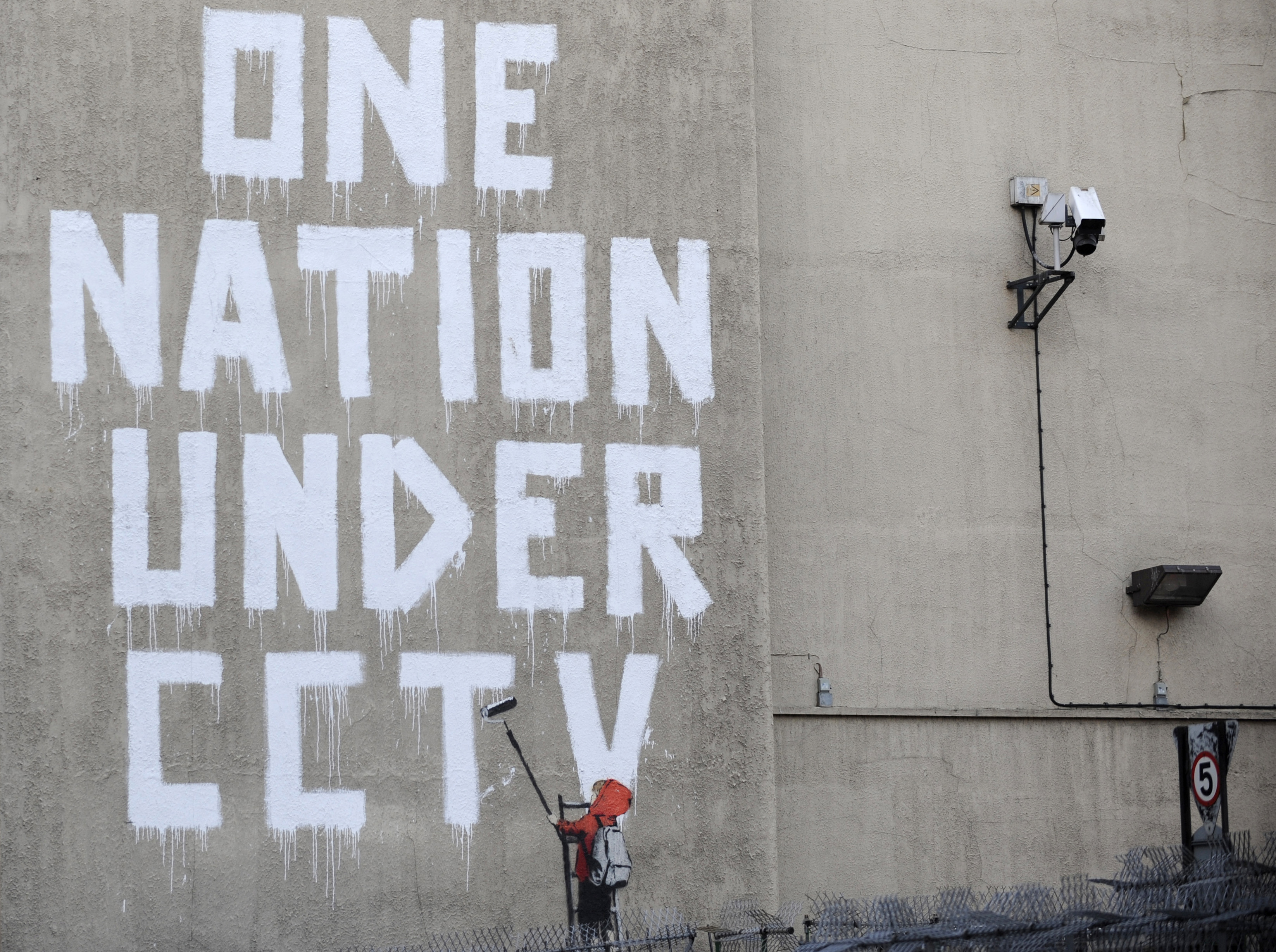Street graffiti by elusive graffiti artist Banksy is seen on a wall in central London