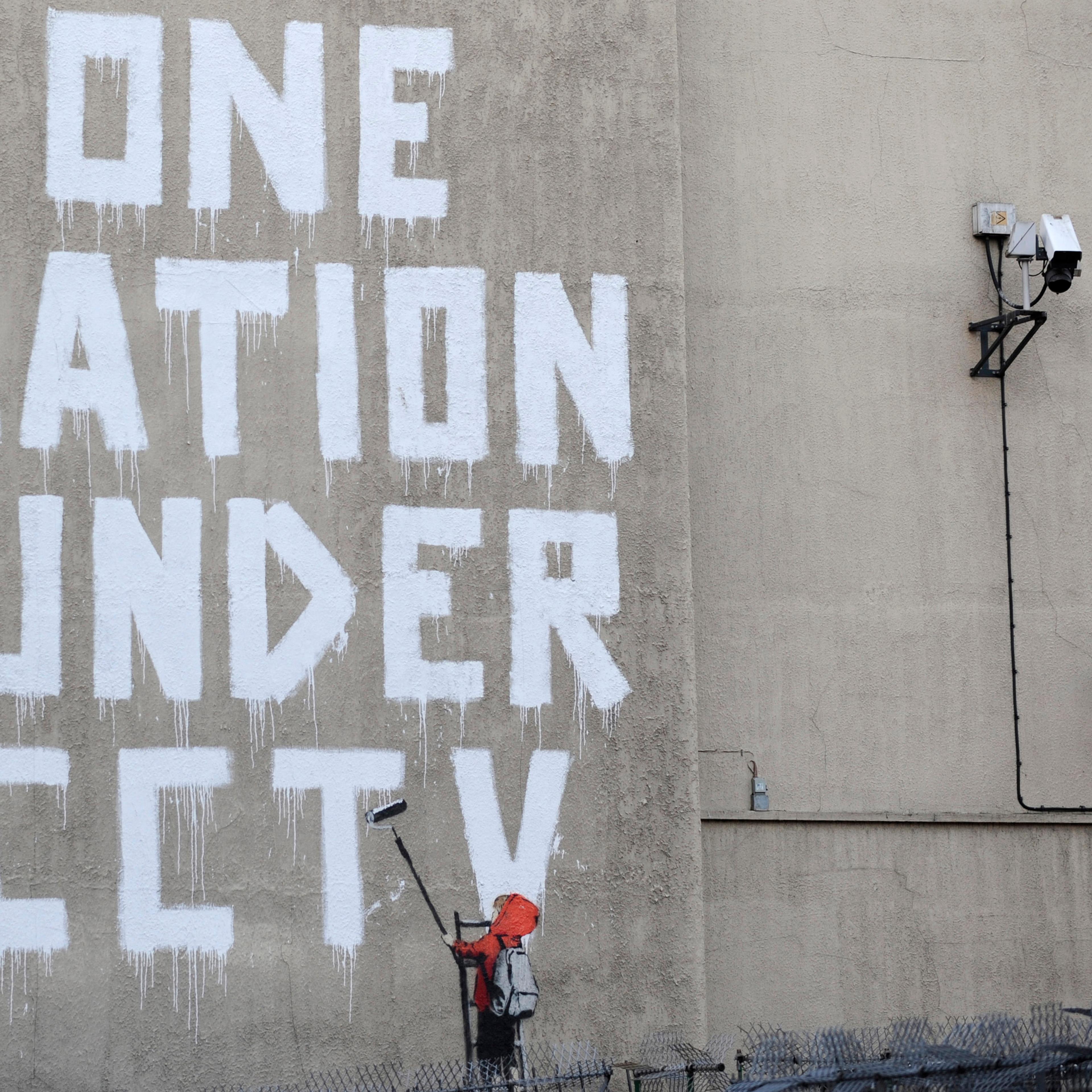 Street graffiti by elusive graffiti artist Banksy is seen on a wall in central London