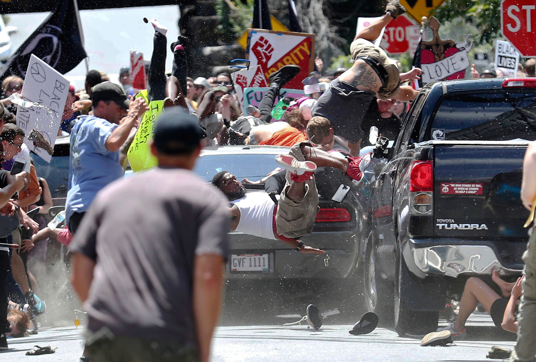 People fly into the air as a vehicle drives into a group of protesters demonstrating against a white nationalist rally in Charlottesville, Va., on Aug. 12, 2017.