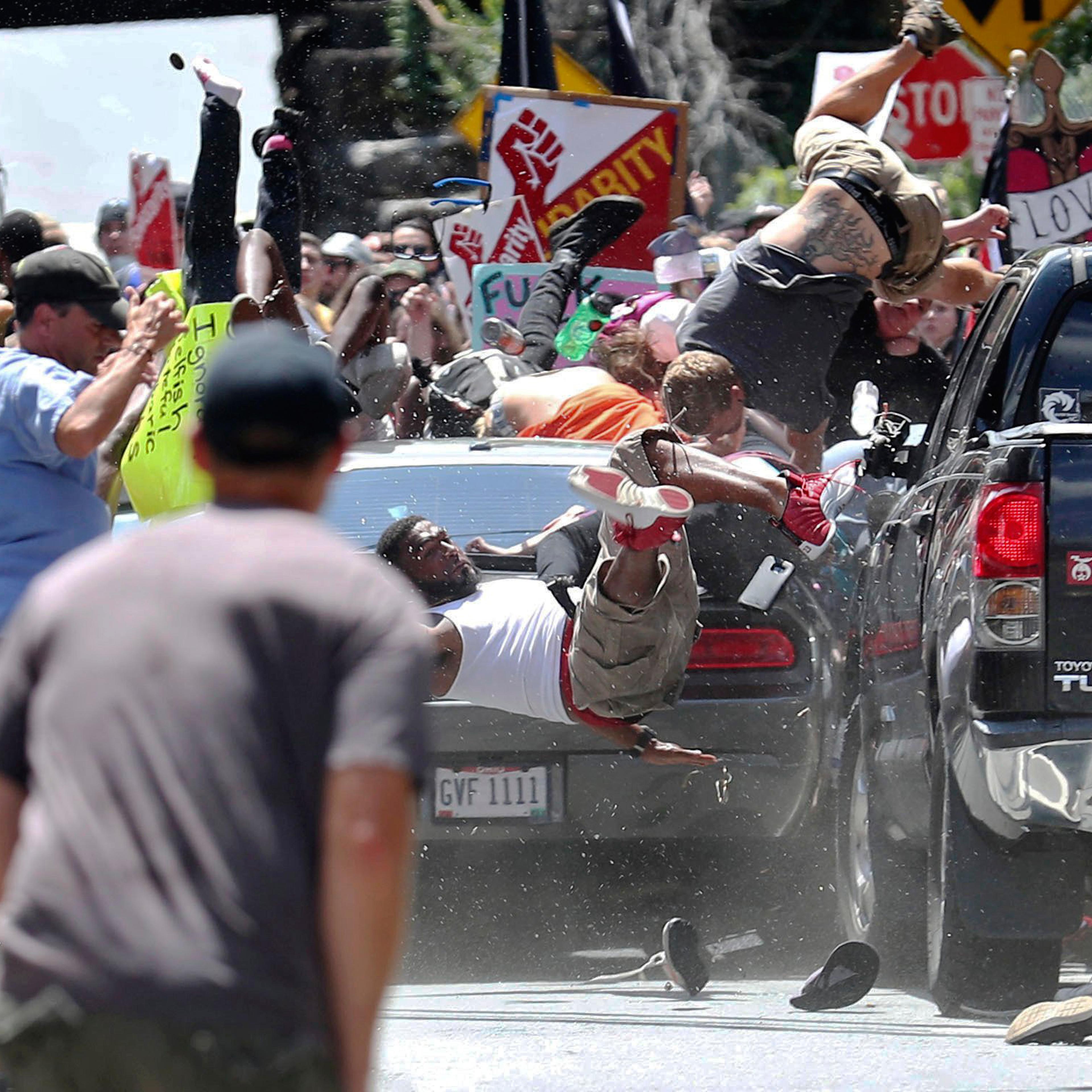 People fly into the air as a vehicle drives into a group of protesters demonstrating against a white nationalist rally in Charlottesville, Va., on Aug. 12, 2017.