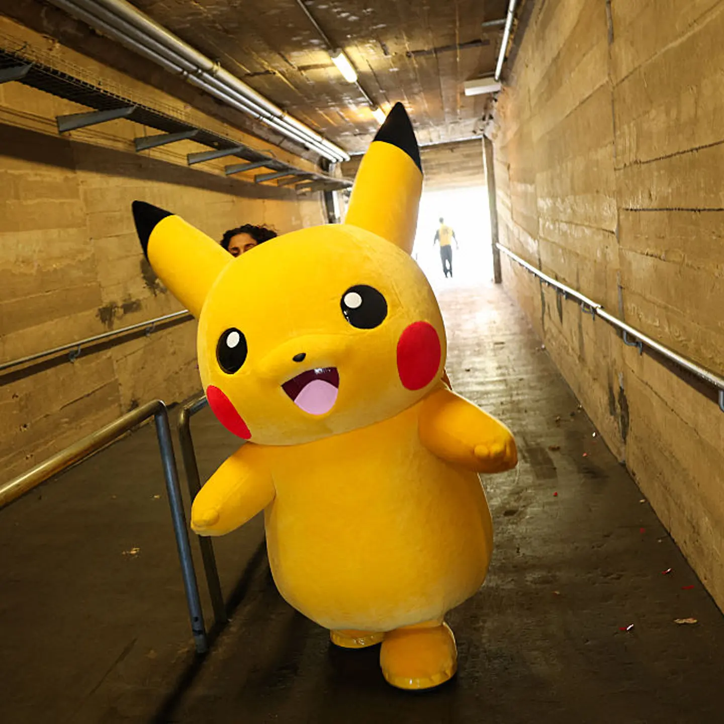 A Pikachu character walks through a tunnel after posing for pictures with fans during the in-person Pokemon GO Tour: Kalos Los Angeles 2026 event at the Rose Bowl Stadium in Pasadena, California, on Feb. 20, 2026.