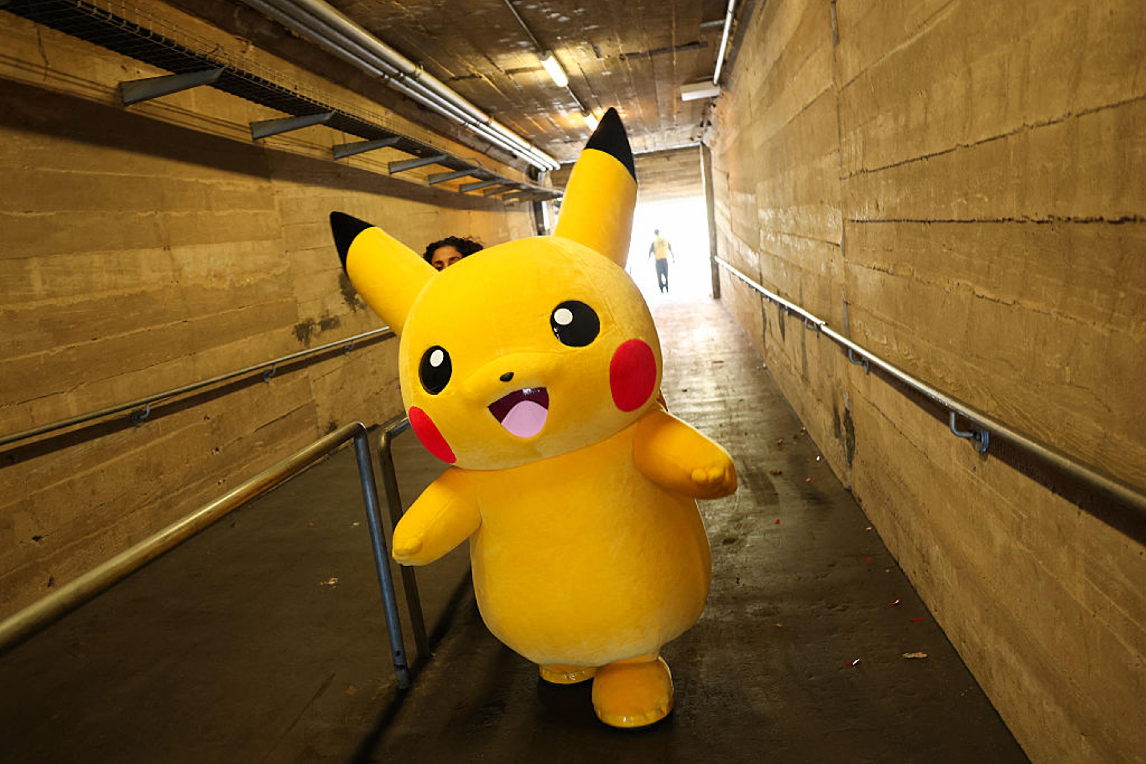 A Pikachu character walks through a tunnel after posing for pictures with fans during the in-person Pokemon GO Tour: Kalos Los Angeles 2026 event at the Rose Bowl Stadium in Pasadena, California, on Feb. 20, 2026.