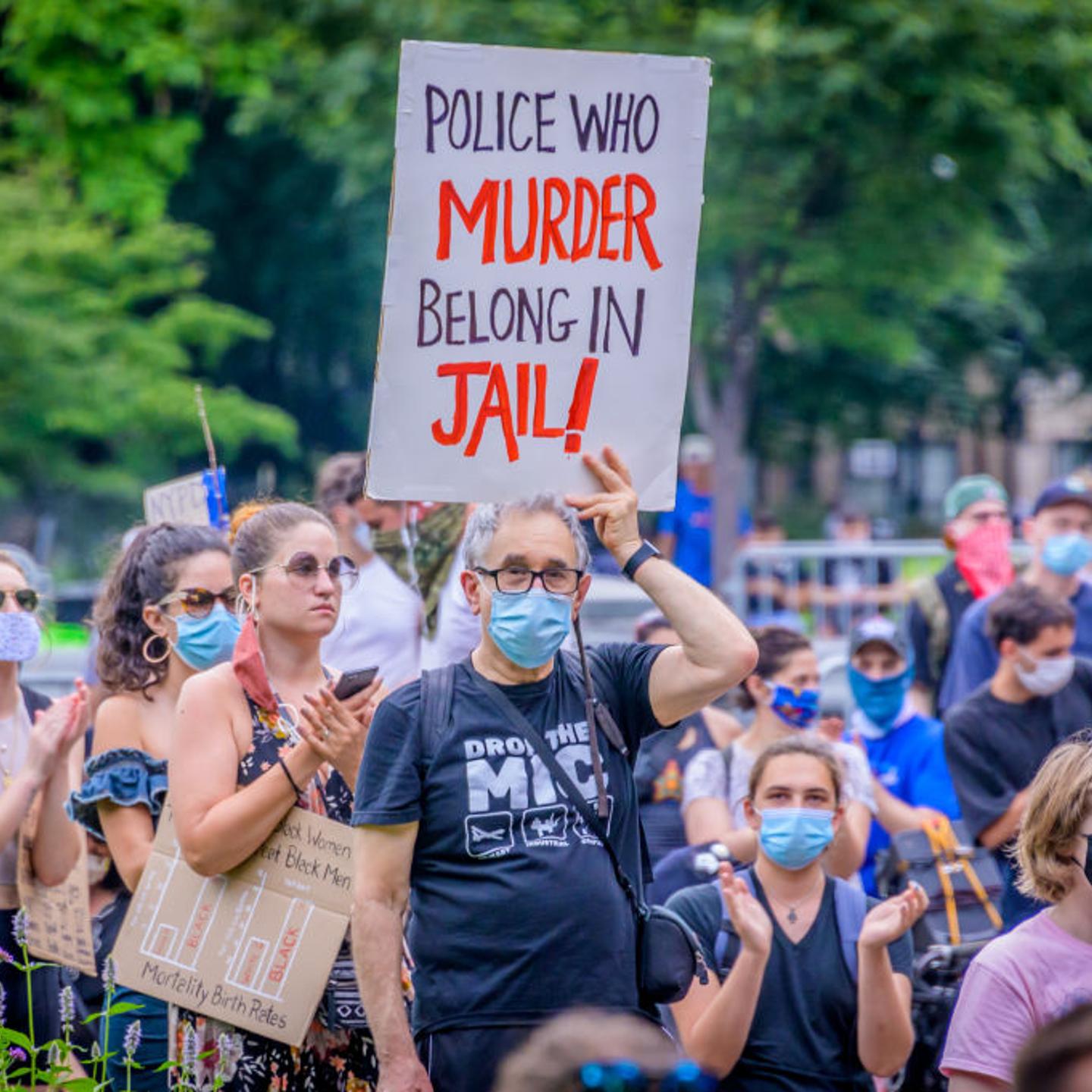 A participant holding a sign at the protest. On the eve of