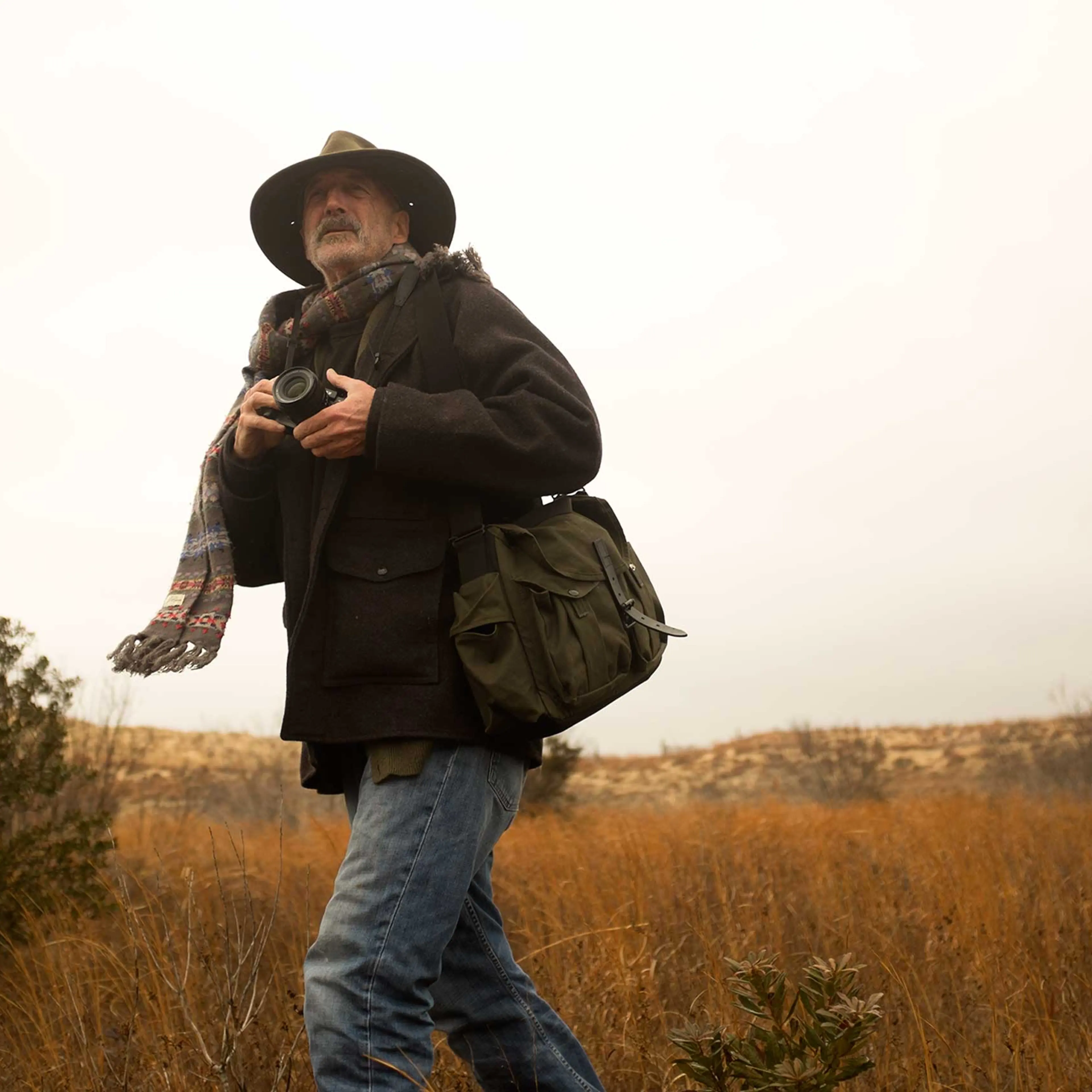 Harvey shooting on location with the bag he designed for Filson