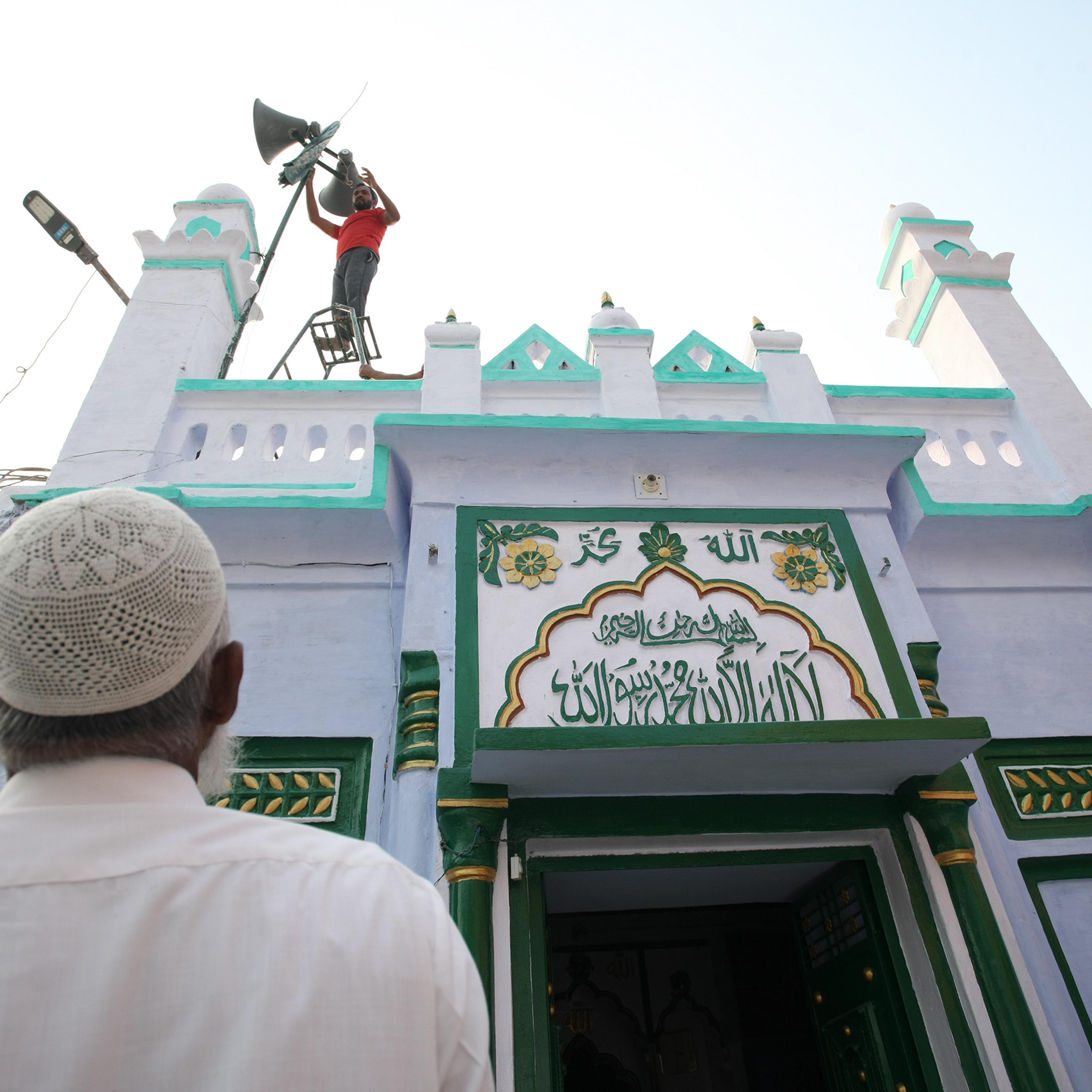 A Indian Muslim man stand outside of a mosque in Ayodhya, India, one day after the Supreme Court's verdict on a disputed religious site, on Nov. 10, 2019.