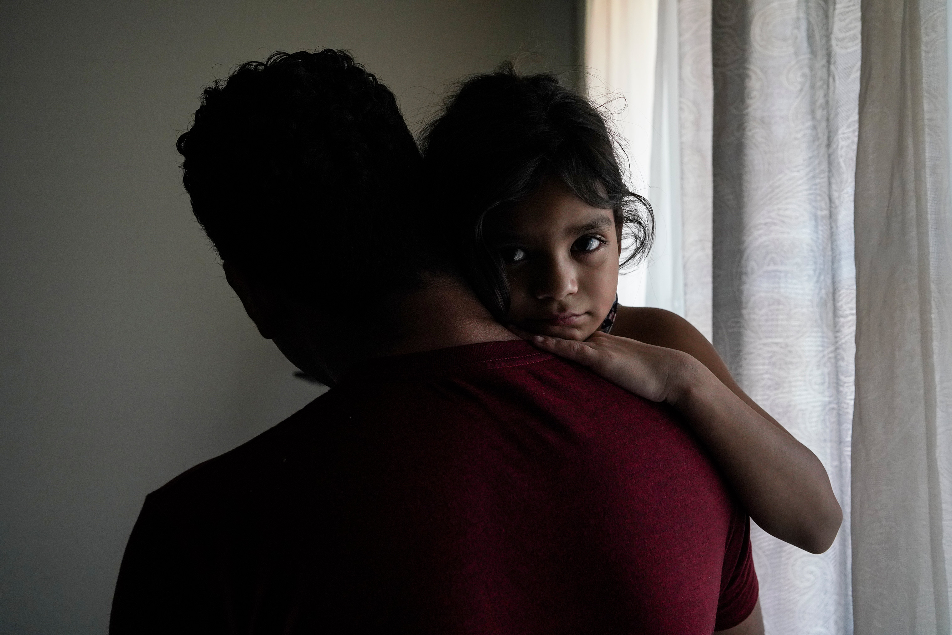 Heyli, 7, holds her dad Carlos at home in Los Angeles, California. They were separated for nearly two months last year after they sought asylum at the Texas border. 