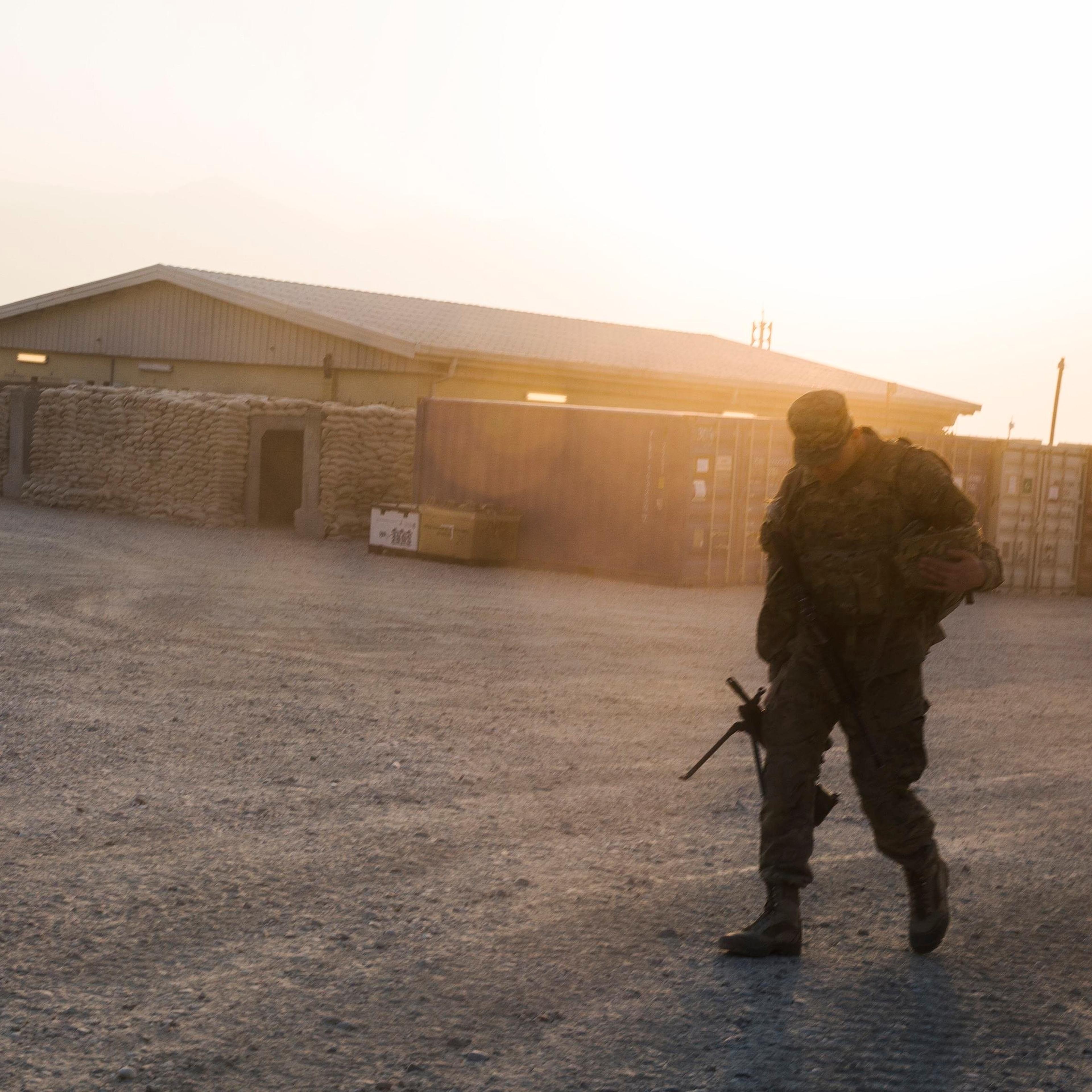 A U.S. soldier from the 3rd Cavalry Regiment walks with his rifle, after returning from a mission at forward operating base Gamberi, in the Laghman province of Afghanistan