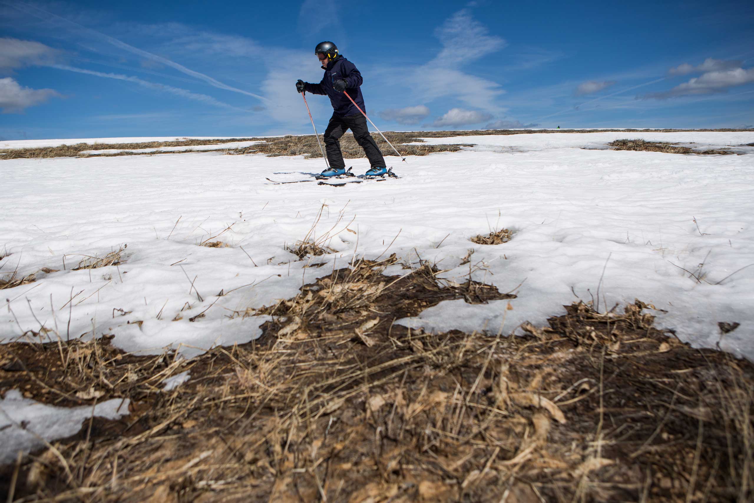 A skier threads his way through patches of dry ground at Squaw Valley Ski Resort in Olympic Valley, Calif., on March 21, 2015.