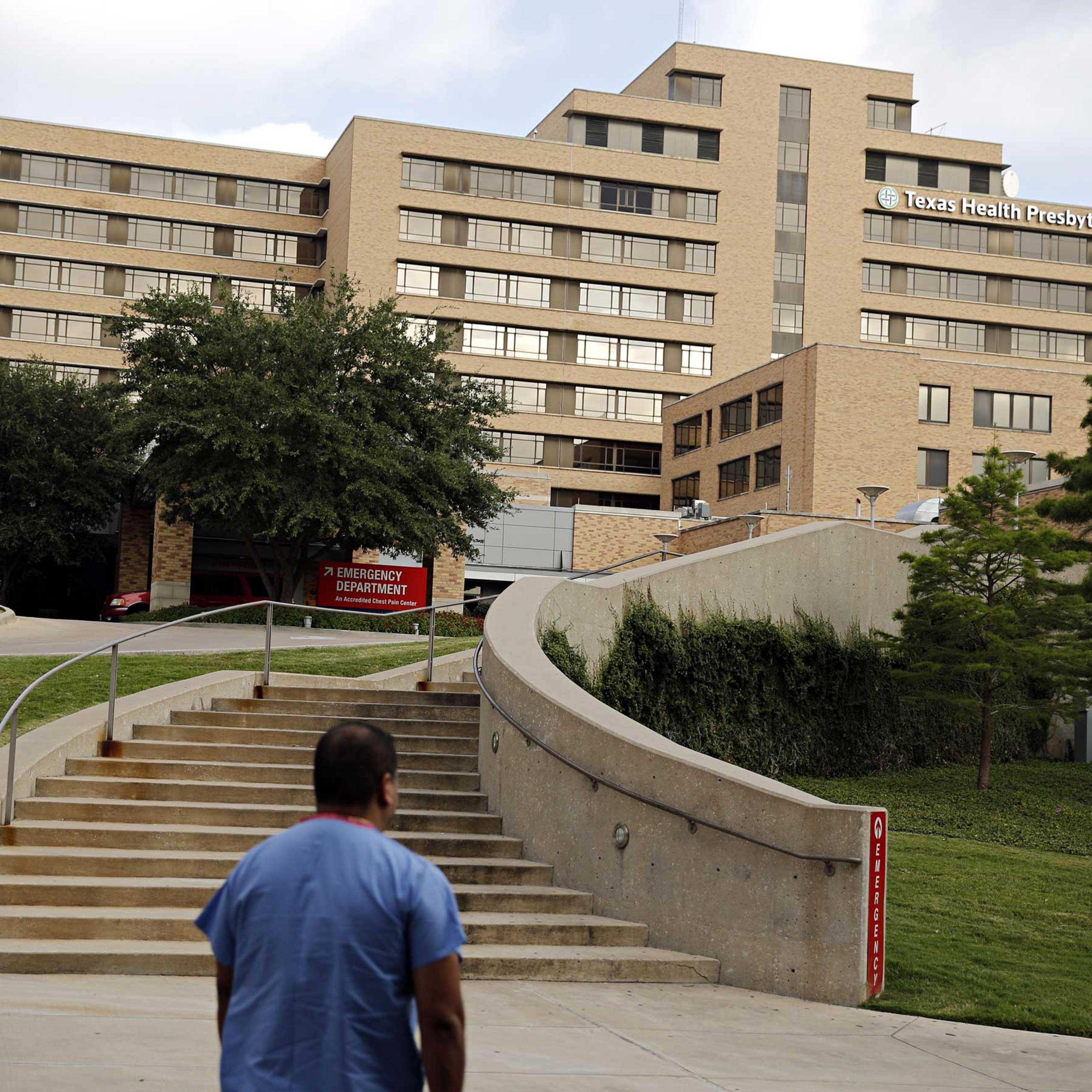 A hospital staffer walks up to the emergency room at Texas Health Presbyterian Hospital, Oct. 1, 2014 in Dallas.