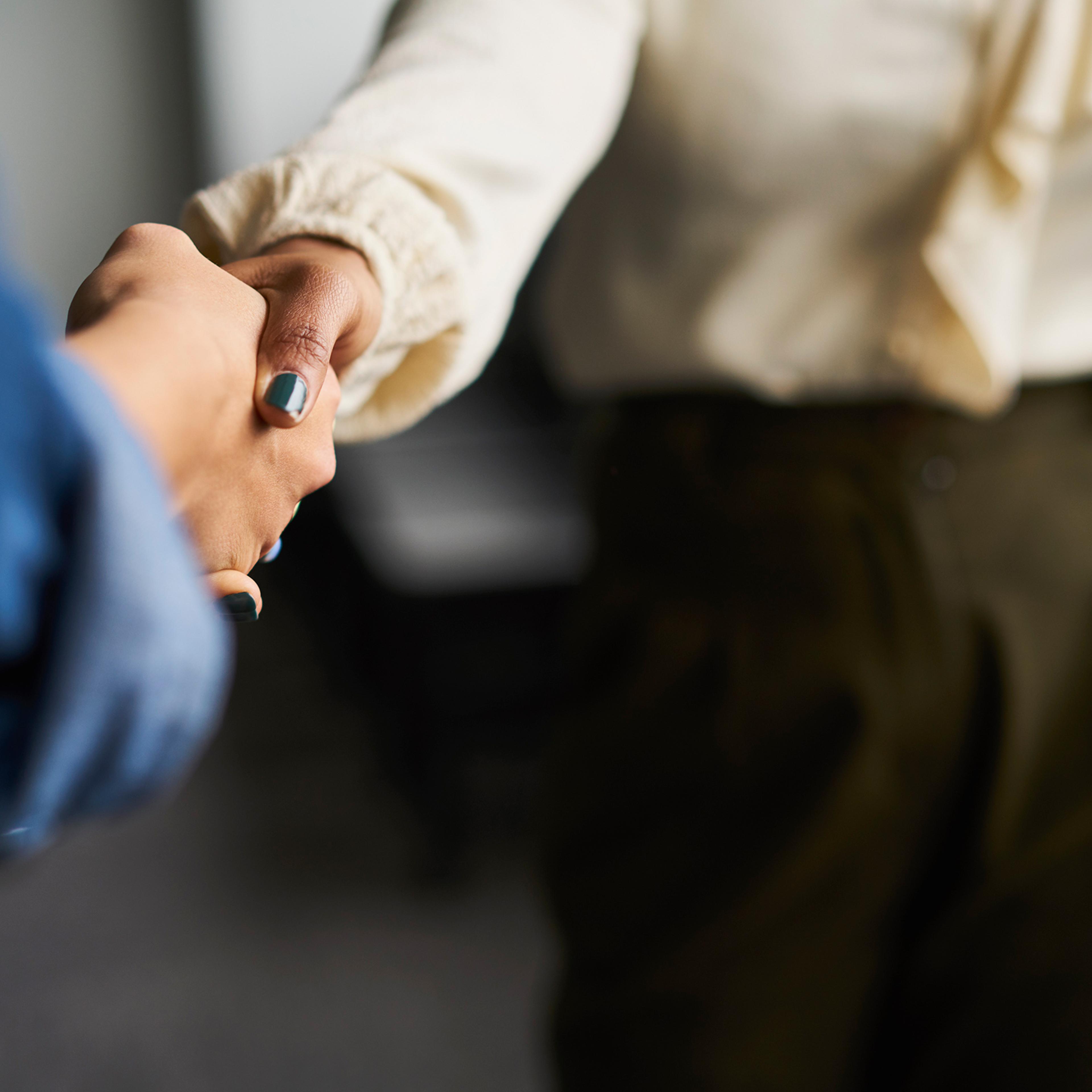 Businesswomen shaking hands in conference room