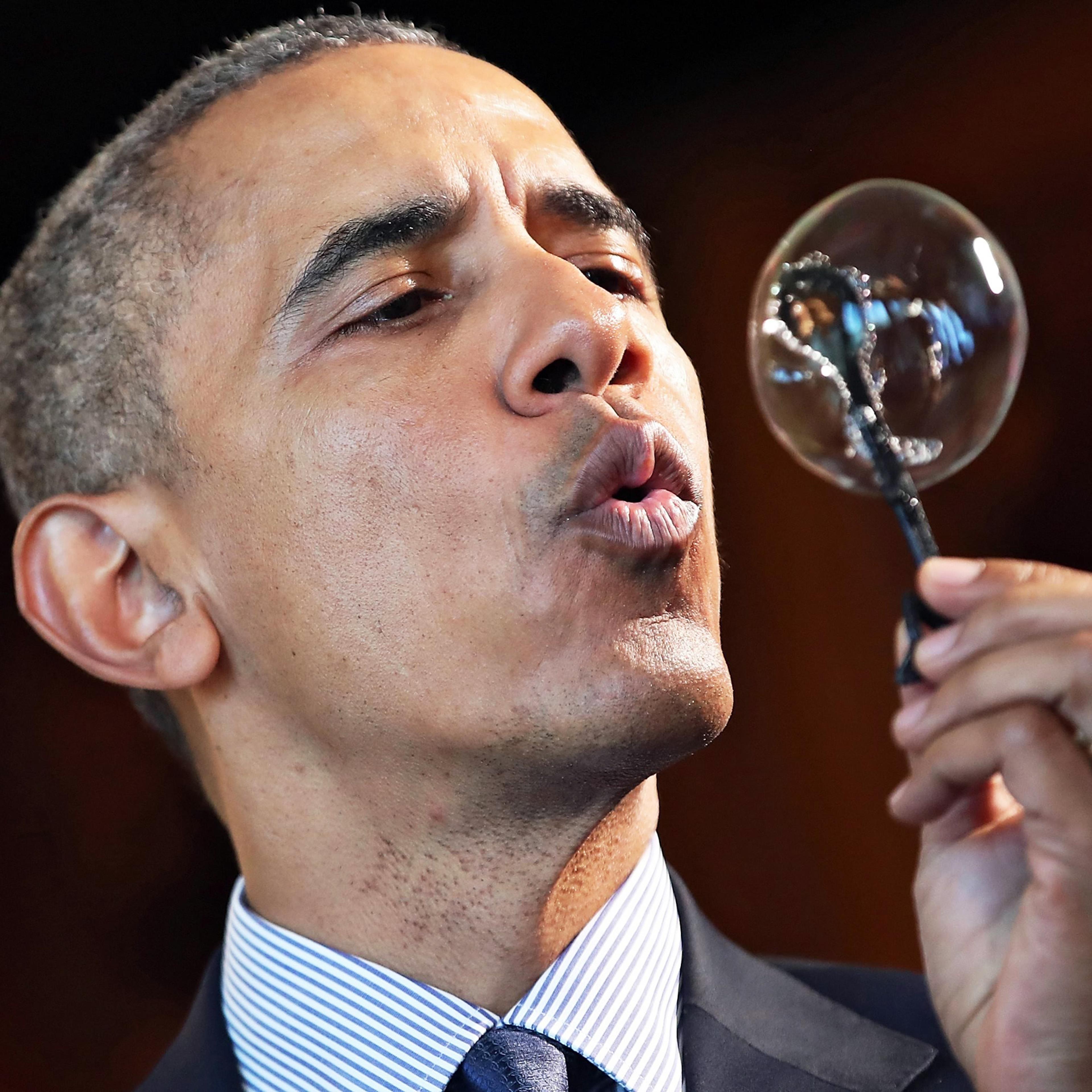 President Barack Obama blows a bubble from a wand made with a 3D printer by nine-year-old Jacob Leggette at the White House Science Fair in Washington on April 13, 2016.