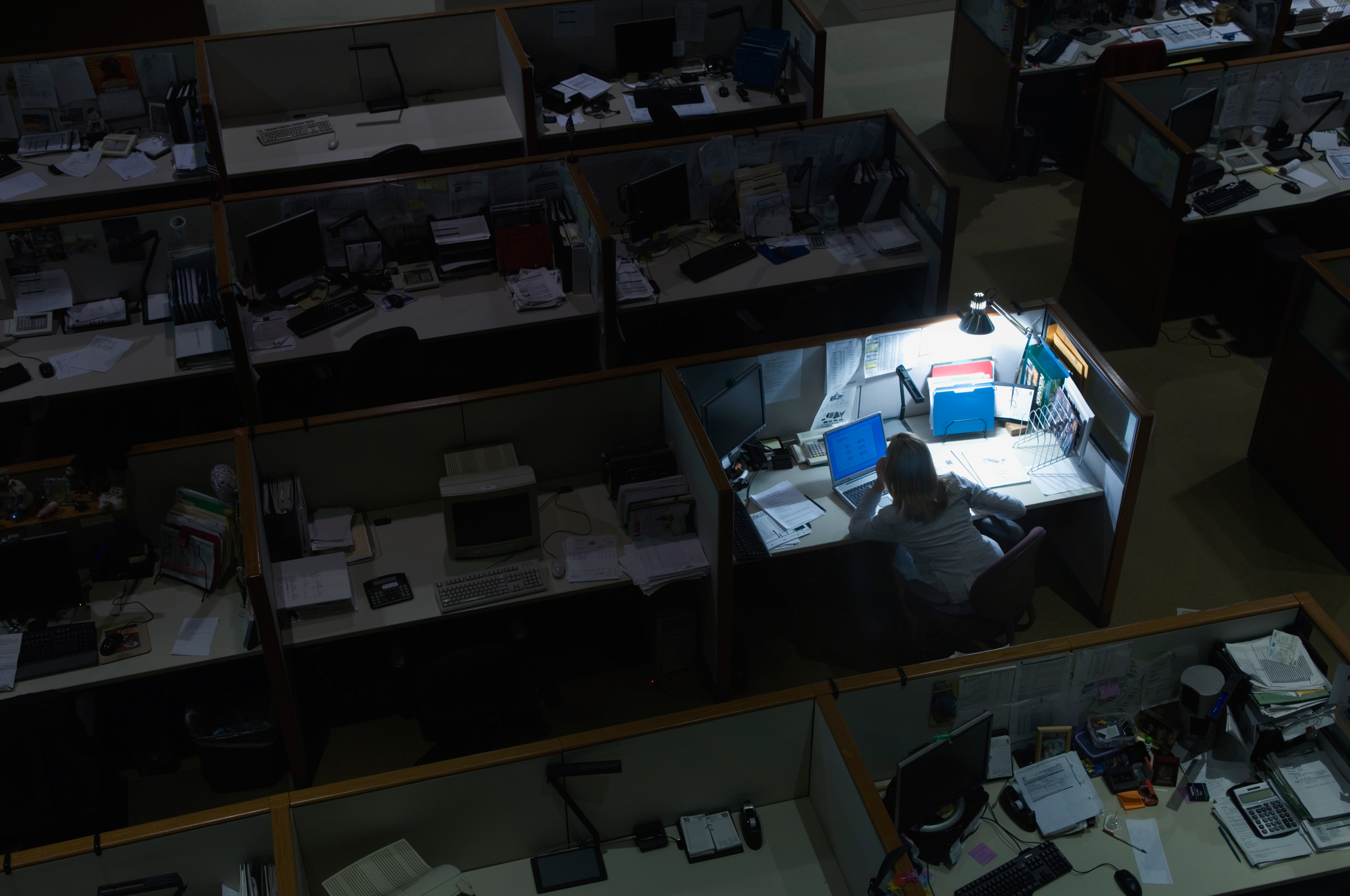 Young woman working late at night in office