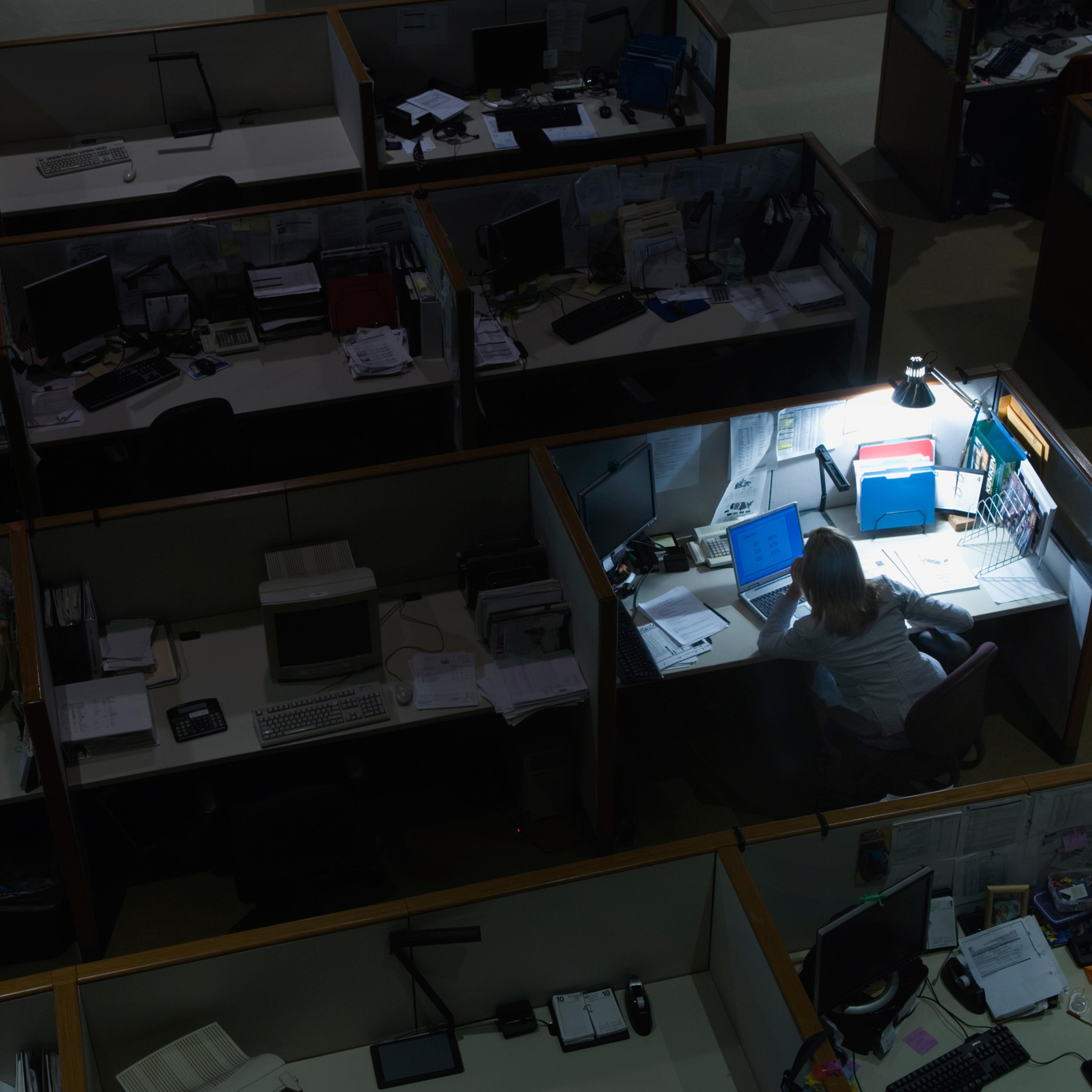 Young woman working late at night in office