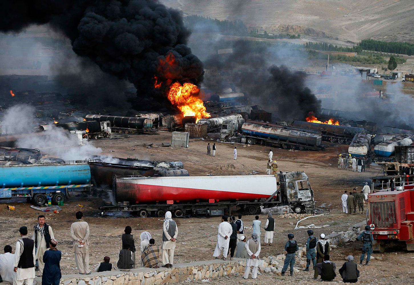 Smoke and flames rise from fuel trucks after an overnight attack by the Taliban on the outskirts of Kabul