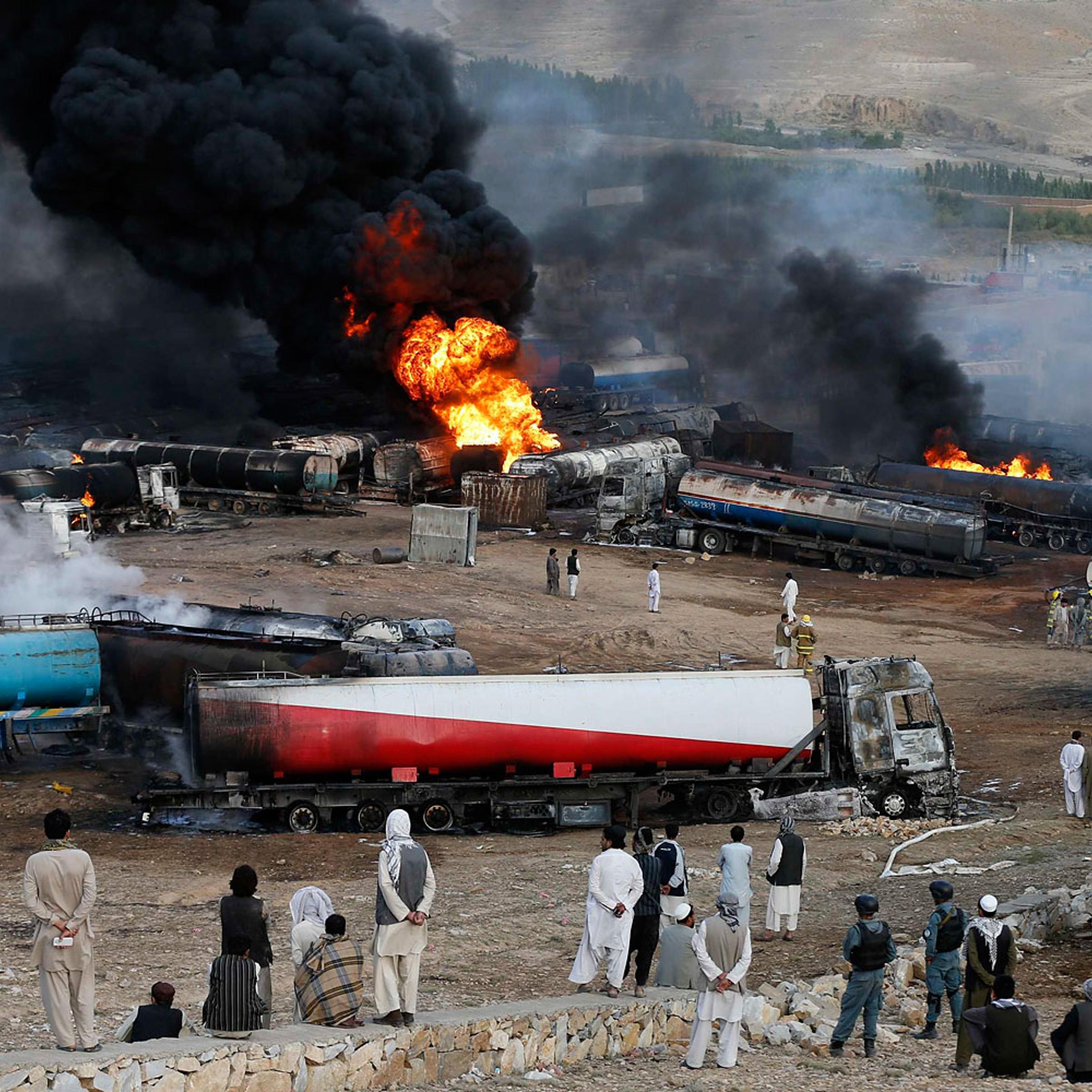 Smoke and flames rise from fuel trucks after an overnight attack by the Taliban on the outskirts of Kabul