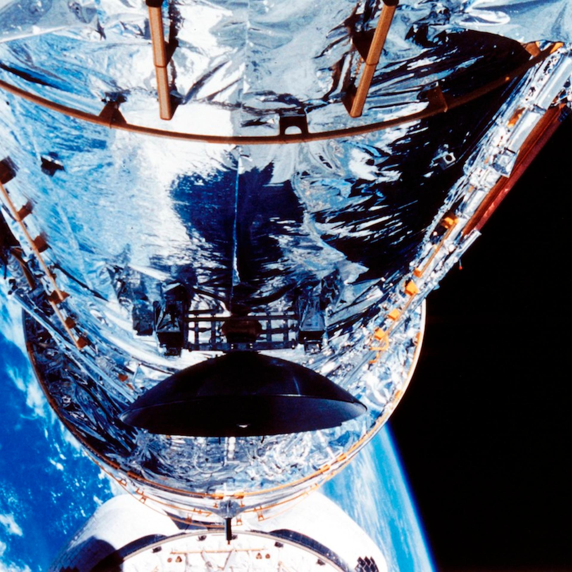 The Hubble Space Telescope orbiting the Earth, c1990s.
