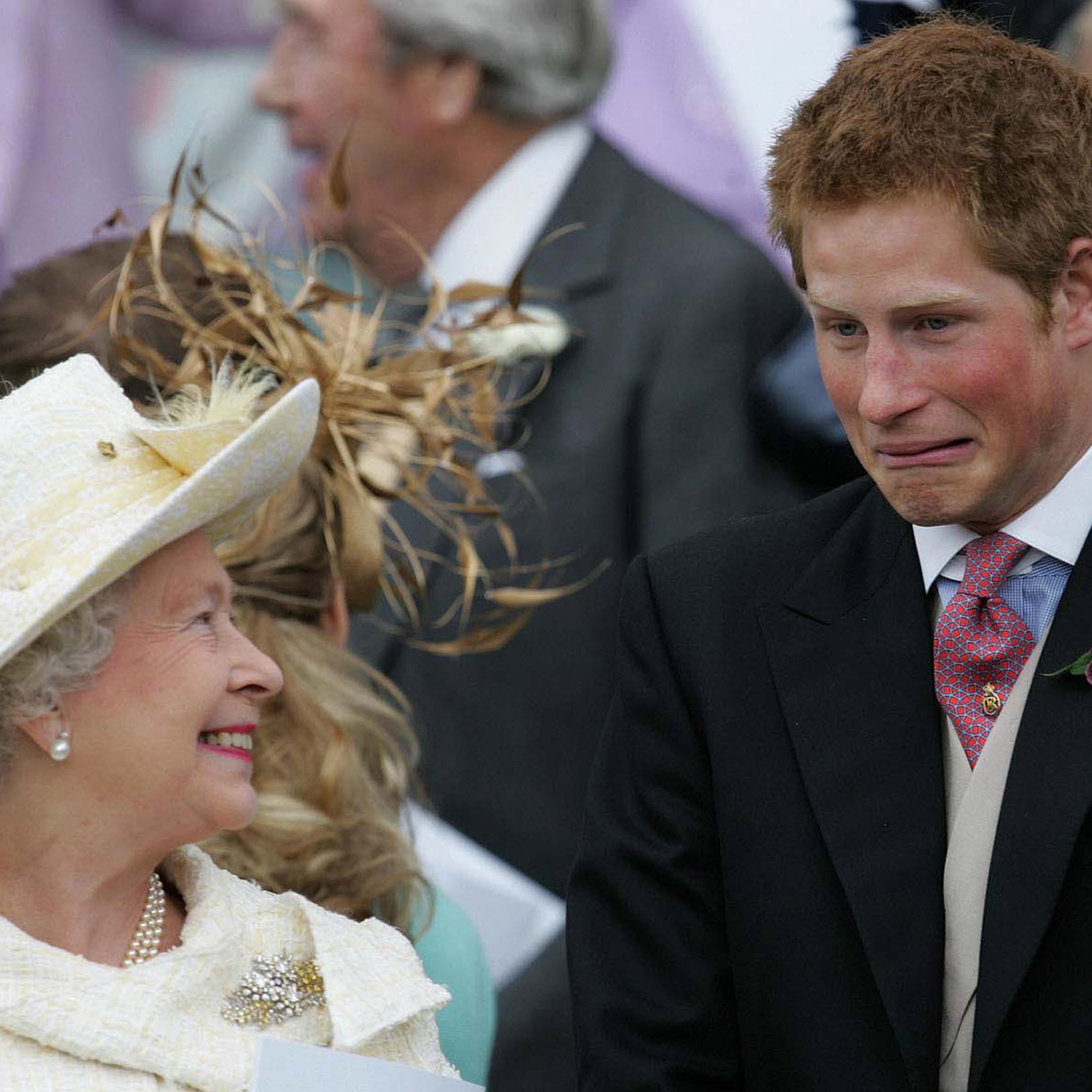 Britain's Queen Elizaberth II smiles as Prince Harry pulls a face as they watch Prince Charles and the ...