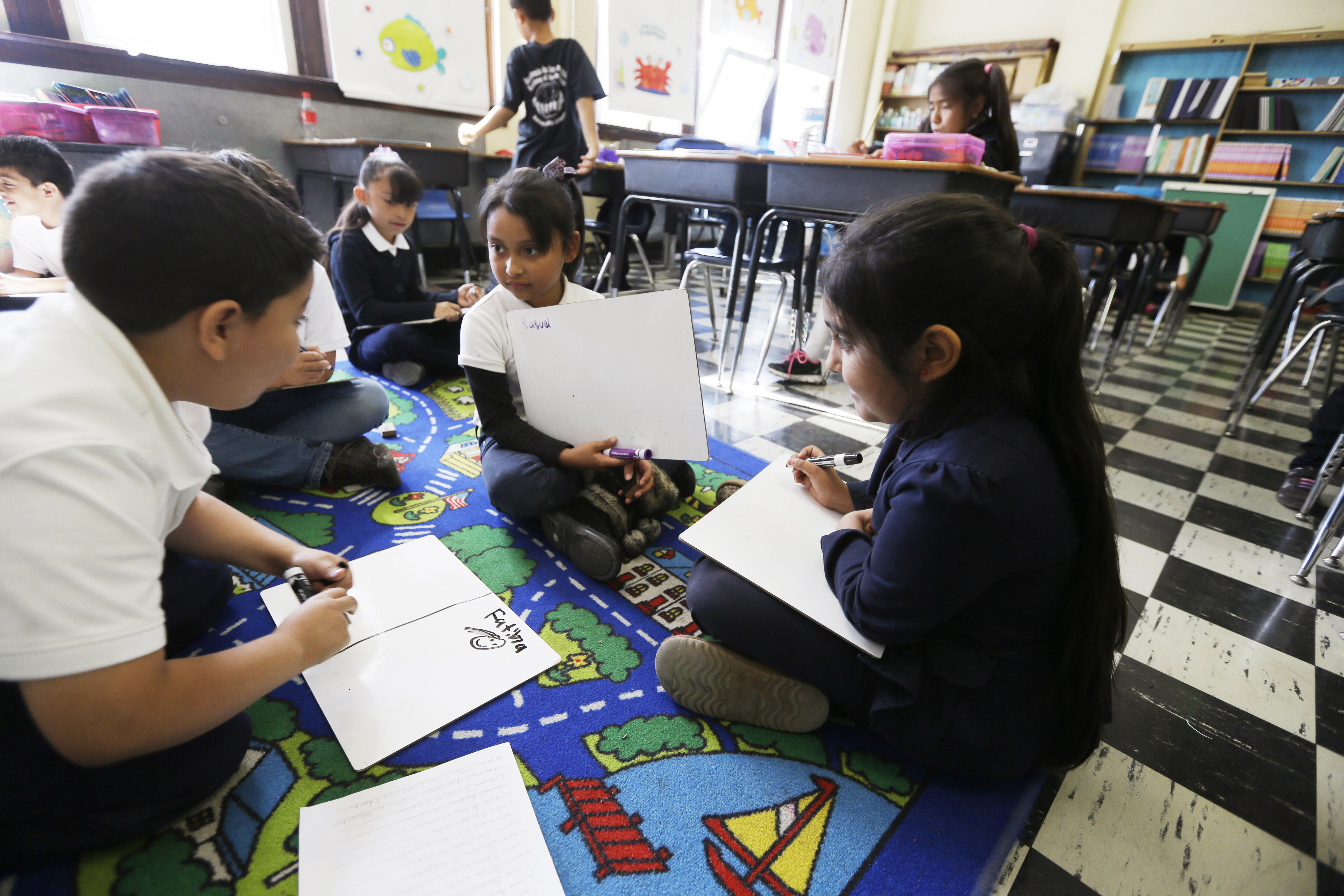 Students work on reading skills at the Detroit Public Schools' Academy of the Americas in Detroit Sept. 19, 2014.