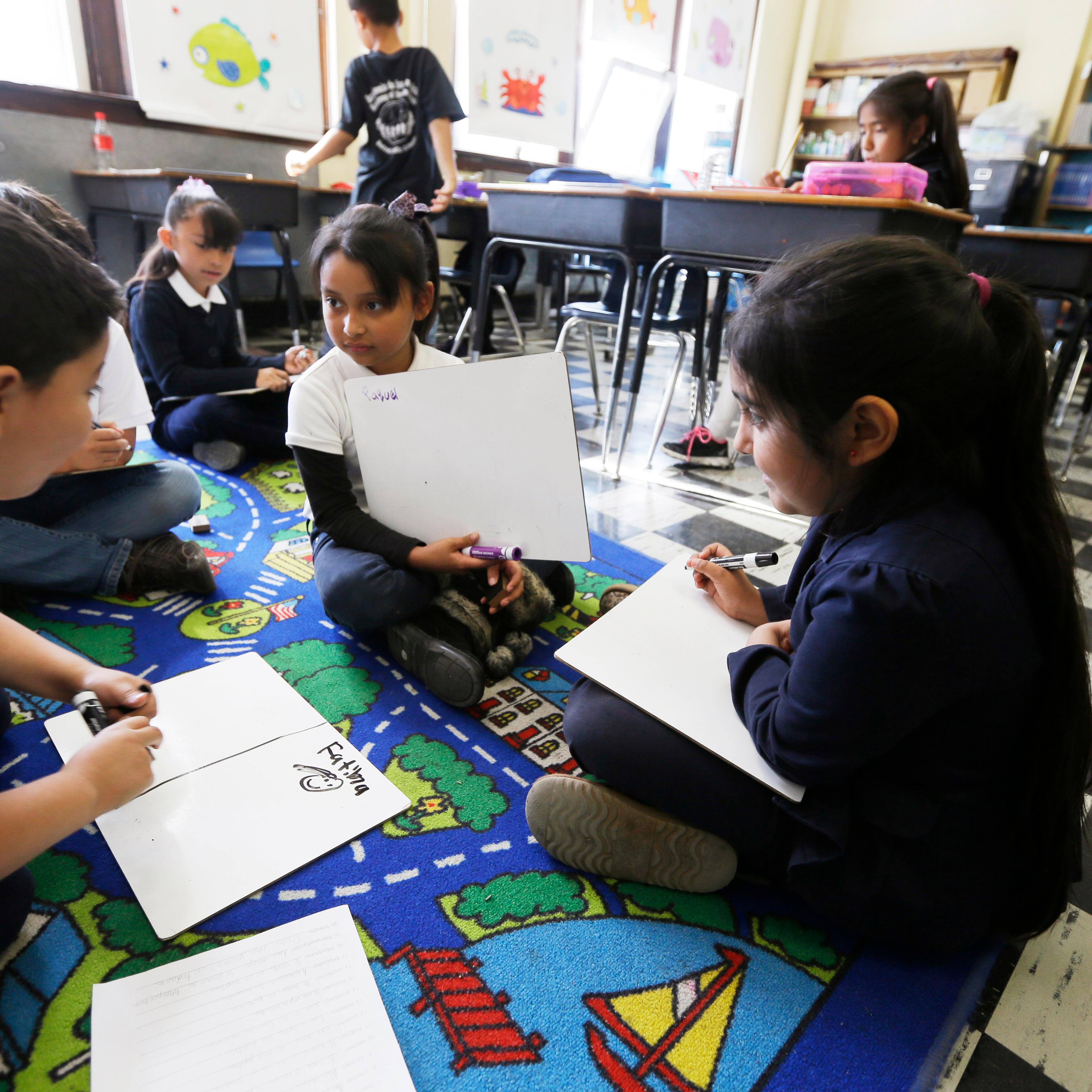 Students work on reading skills at the Detroit Public Schools' Academy of the Americas in Detroit Sept. 19, 2014.