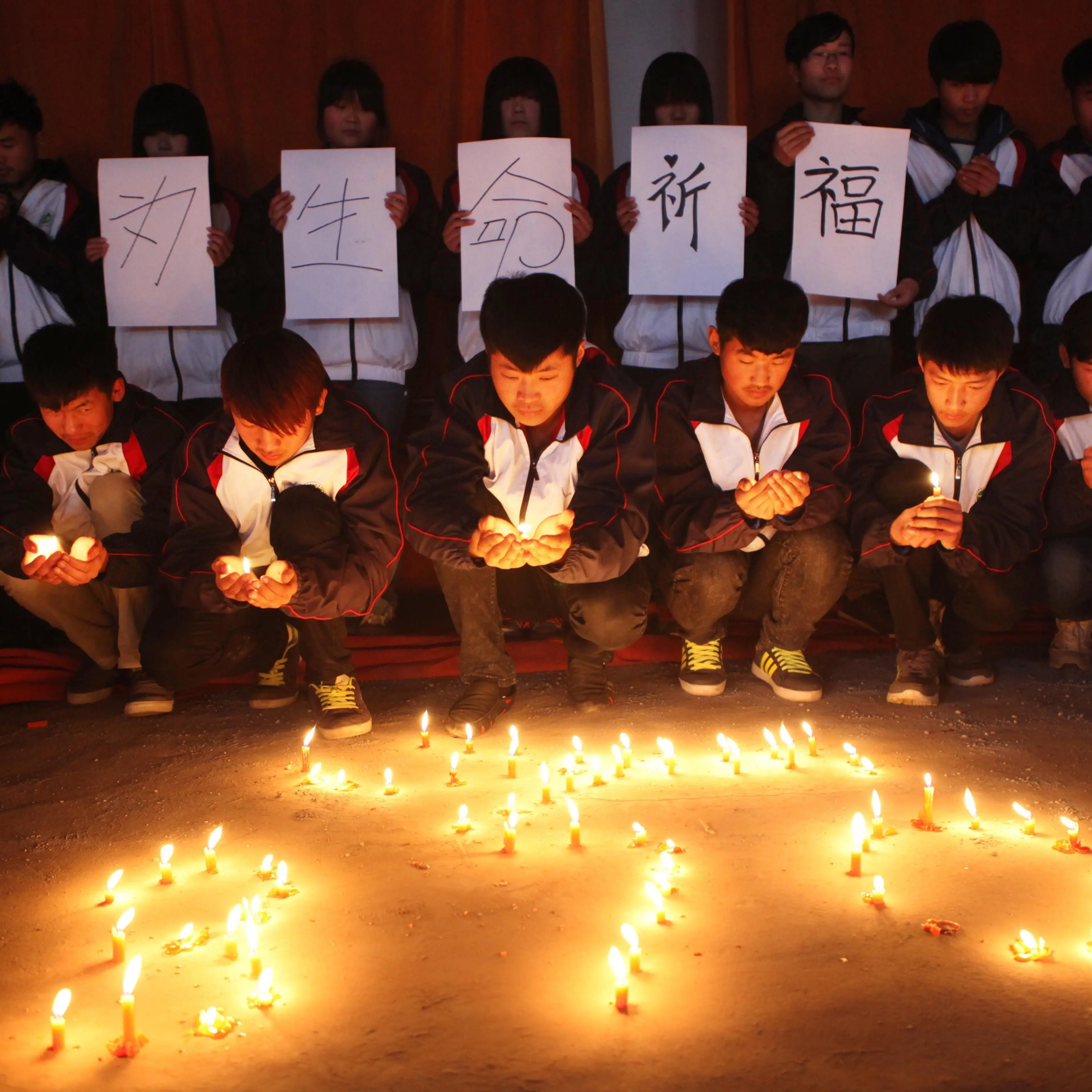High school students in Lianyungang in Chinas eastern Jiangsu province hold a vigil for the passengers and crew of Flight MH 370