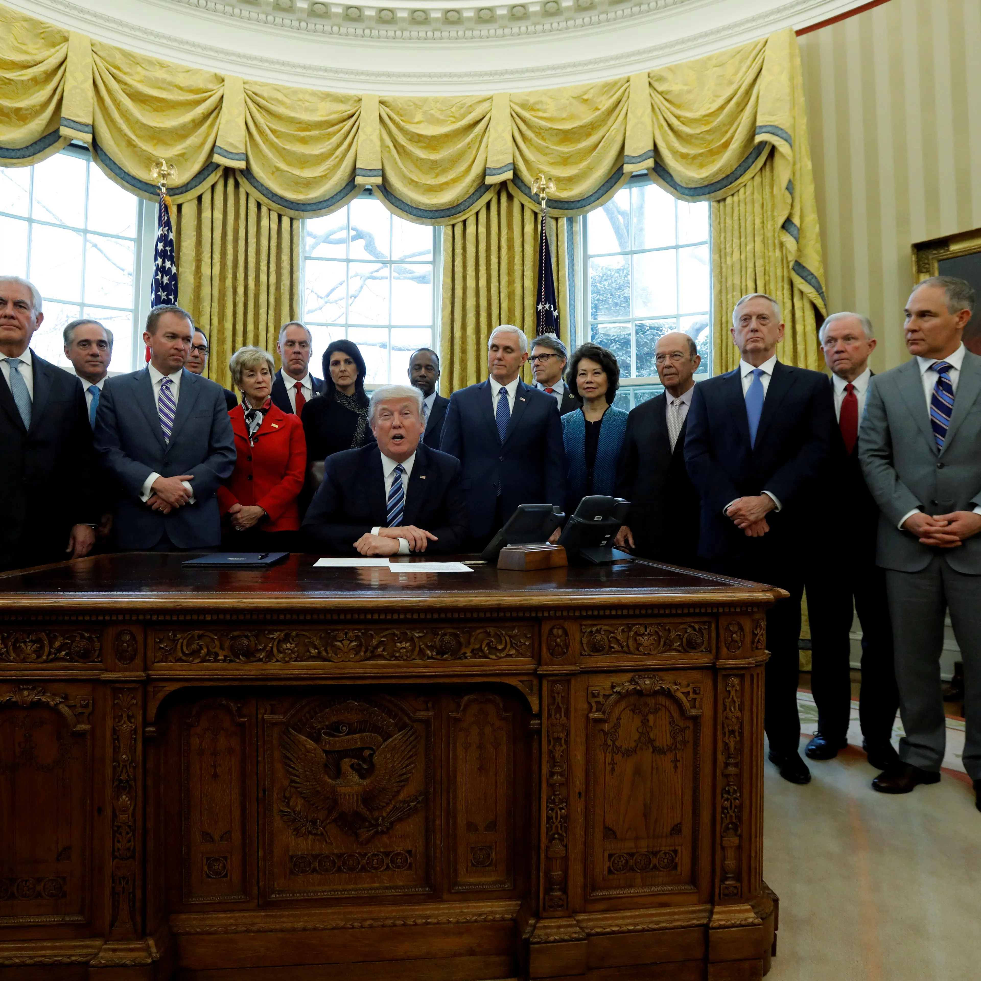 Trump signs an executive order in the Oval Office at the White House in Washington