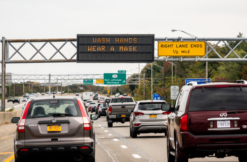 A traffic sign reads, "wash hands, wear a mask" in New York City on Oct. 25, 2020.