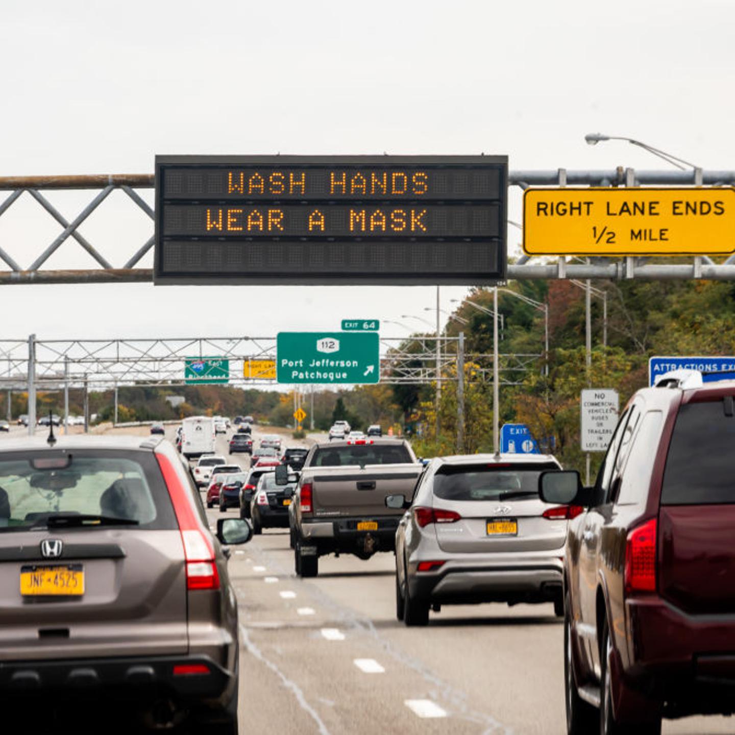 A traffic sign reads, "wash hands, wear a mask" in New York City on Oct. 25, 2020.