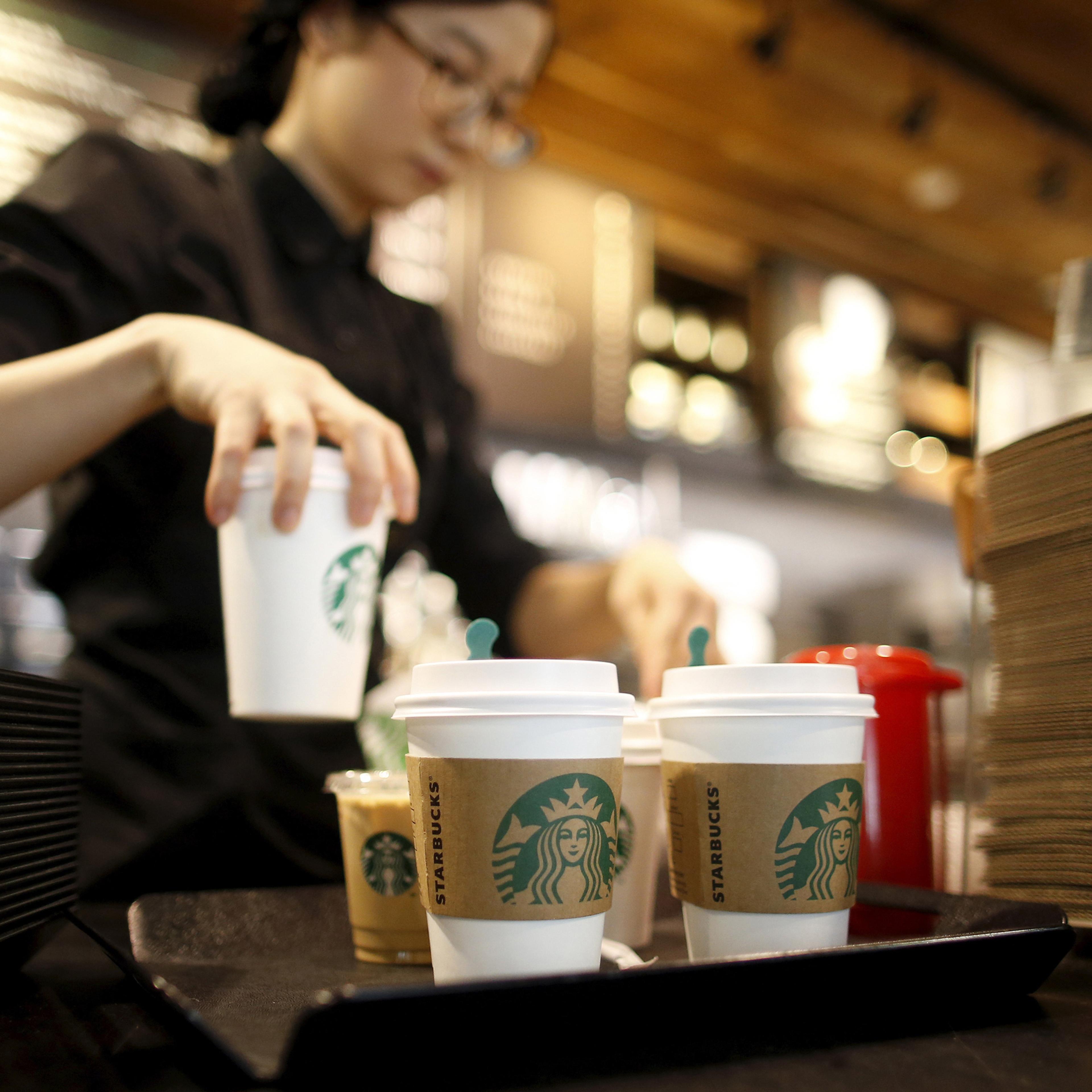 A staff serves beverages at a Starbucks coffee shop in Seoul, South Korea, March 7, 2016. Picture taken March 7, 2016. REUTERS/Kim Hong-Ji - RTSDL07