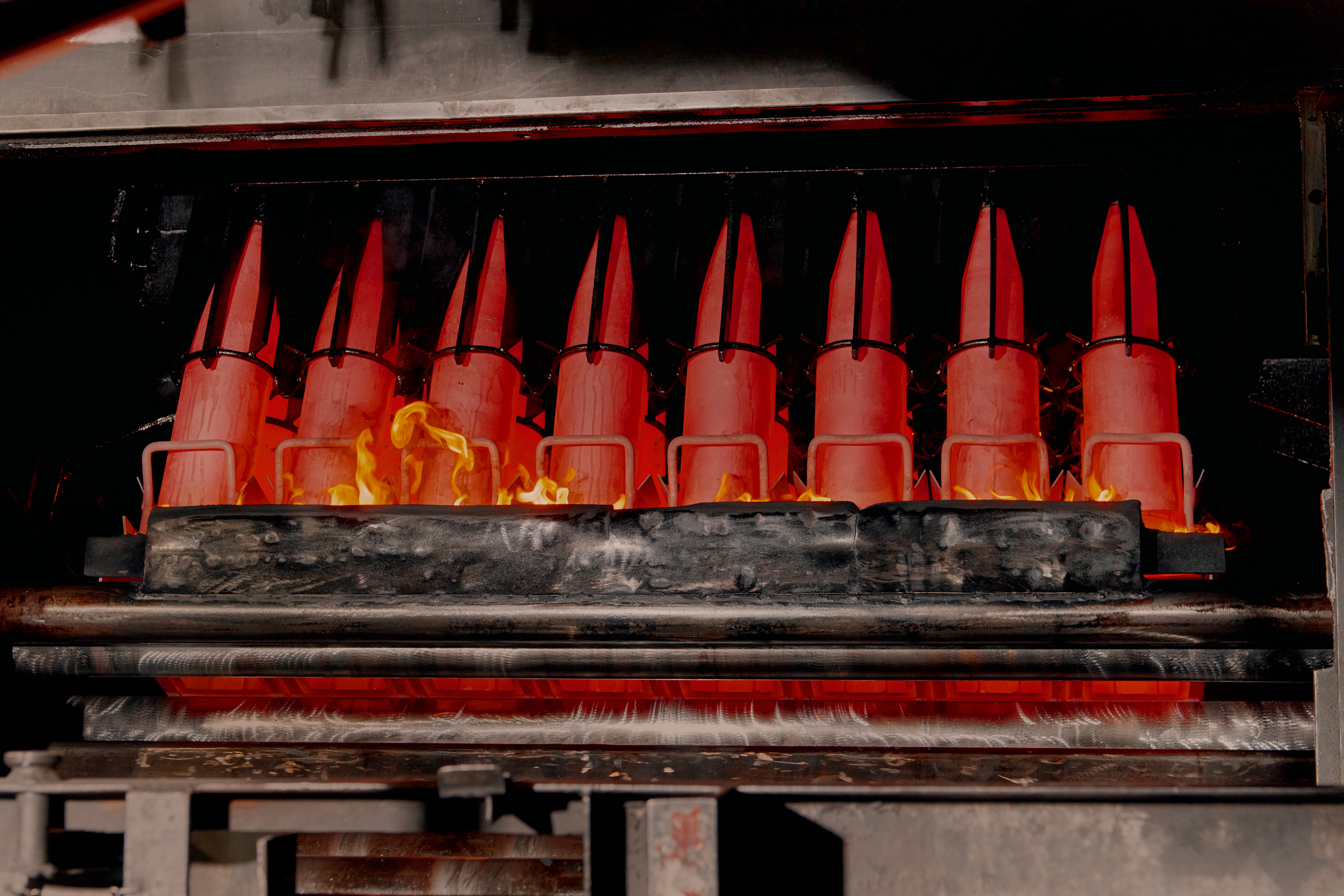 Artillery shells stand over an oil “bath” that’s designed to cool them before the final stages of assembly.