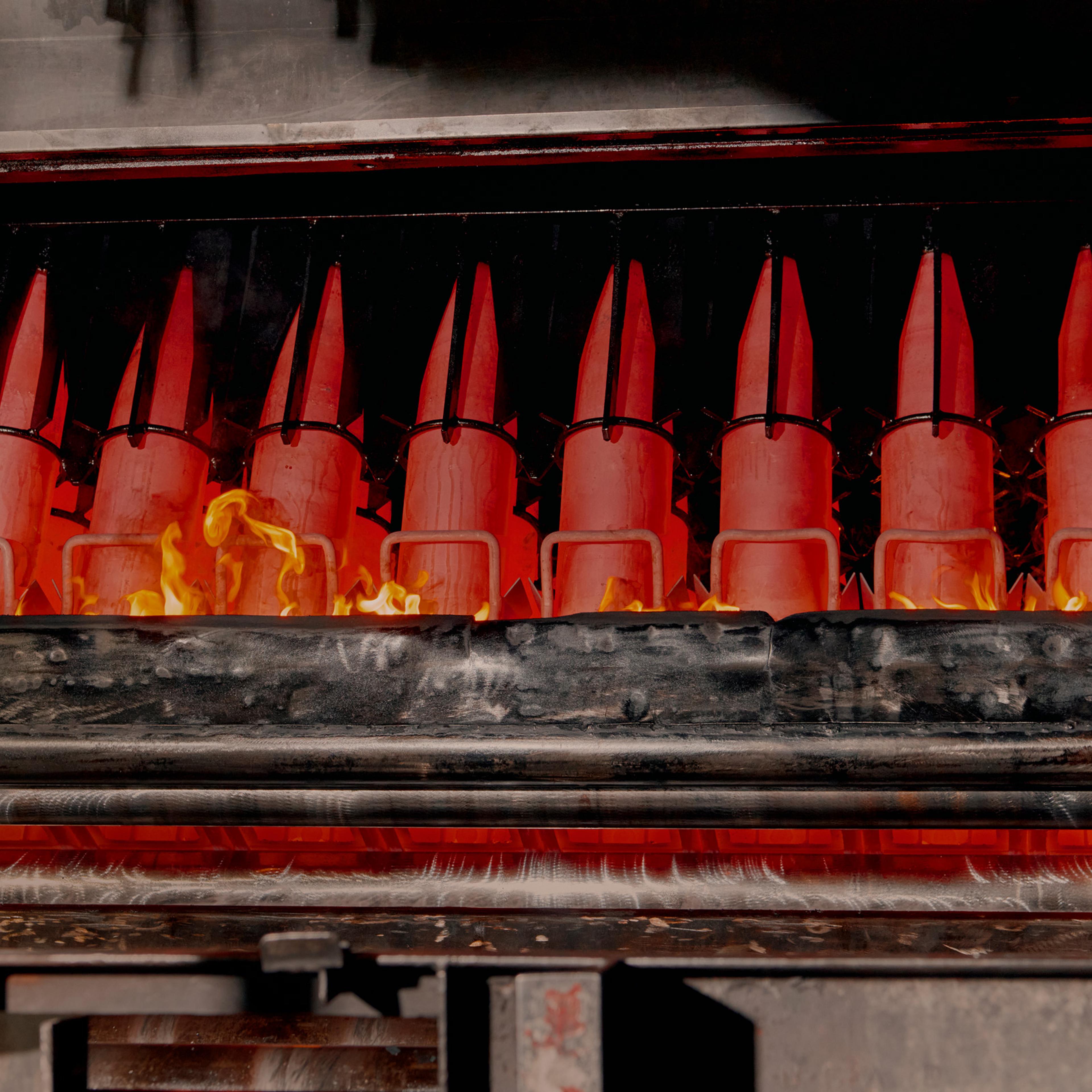 Artillery shells stand over an oil “bath” that’s designed to cool them before the final stages of assembly.