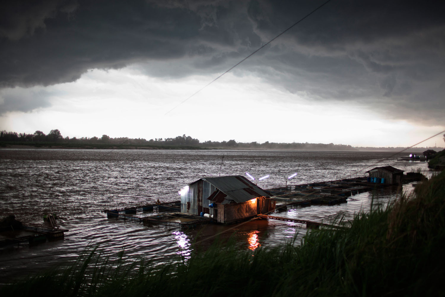 An afternoon storm approaches a fish farm on the Mekong River in Vientiane, Laos People’s Democratic Republic on May 12, 2011.