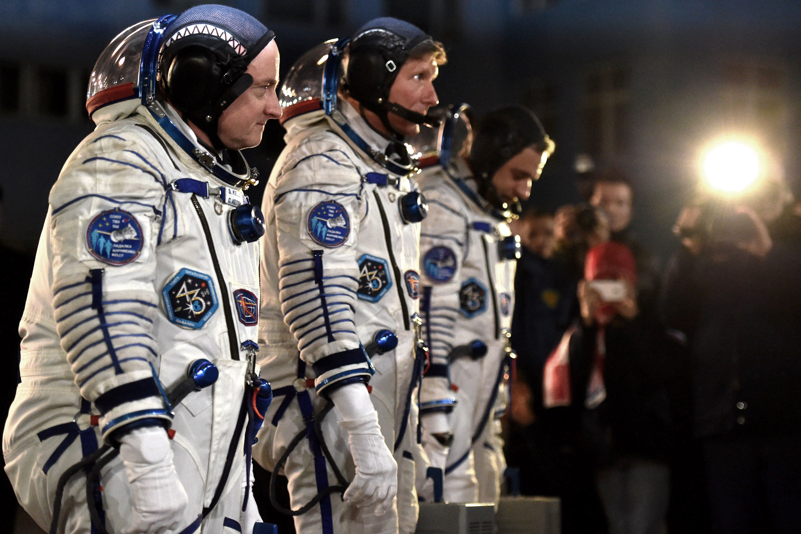 From left: US astronaut Scott Kelly and Russian cosmonauts Gennady Padalka and Mikhail Kornienko walk after their space suits were tested at the Russian-leased Baikonur cosmodrome late on March 27, 2015
