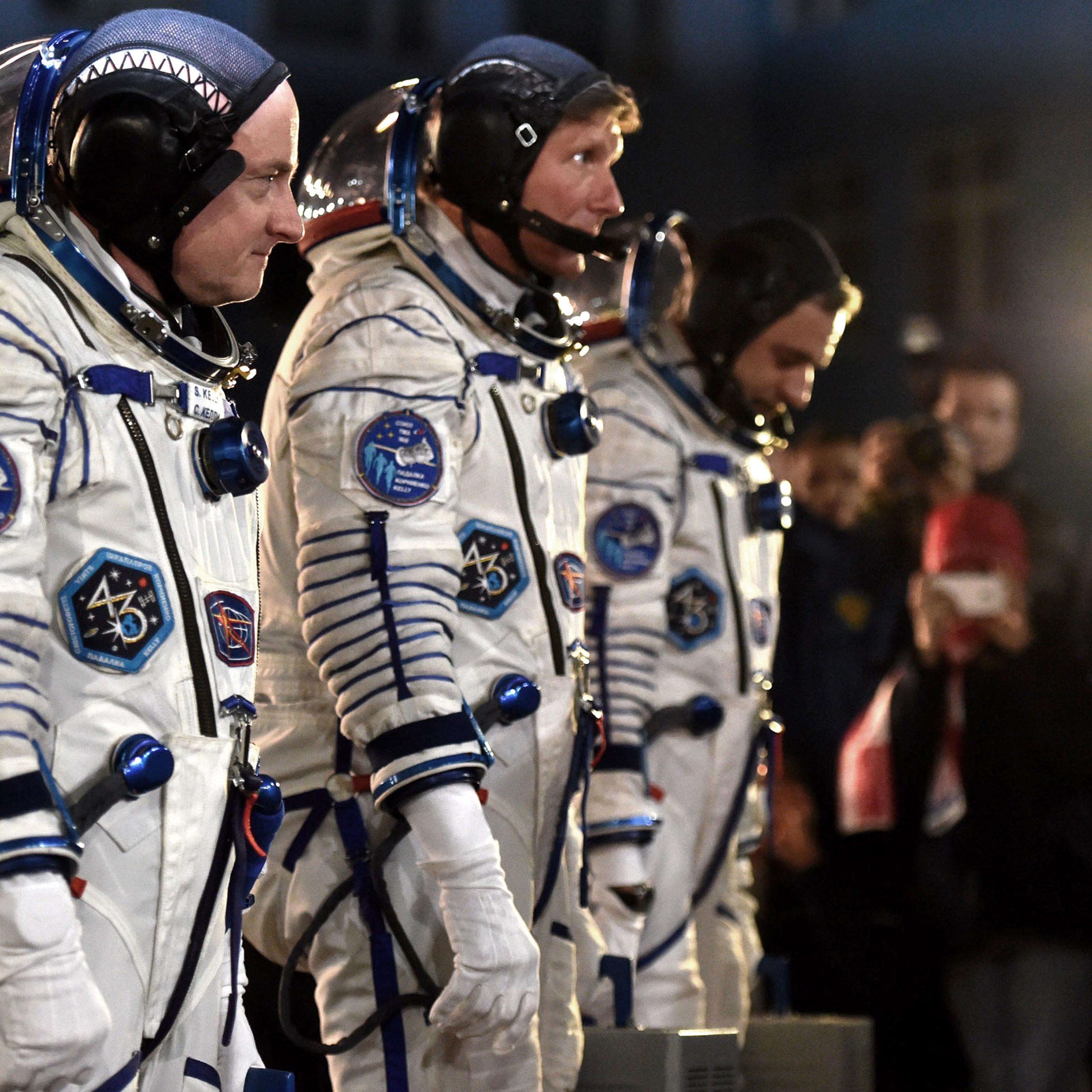 From left: US astronaut Scott Kelly and Russian cosmonauts Gennady Padalka and Mikhail Kornienko walk after their space suits were tested at the Russian-leased Baikonur cosmodrome late on March 27, 2015