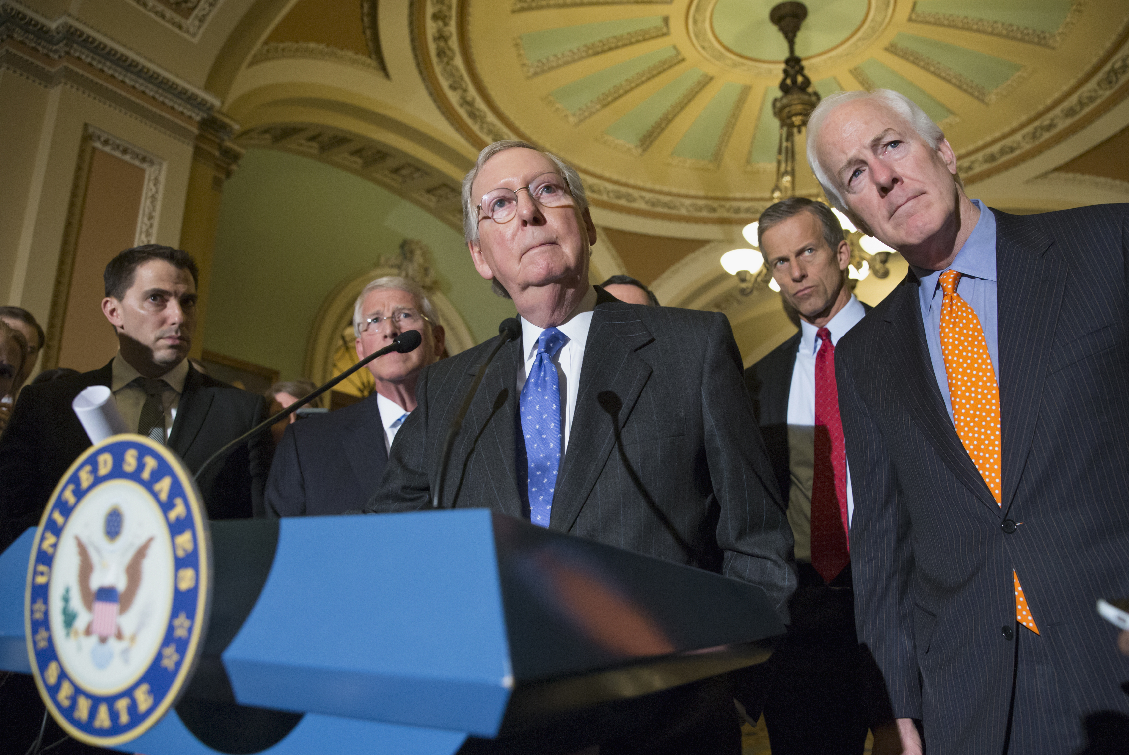 Mitch McConnell, center, speaks with reporters on Capitol Hill in Washington, D.C. on Feb. 23, 2016.