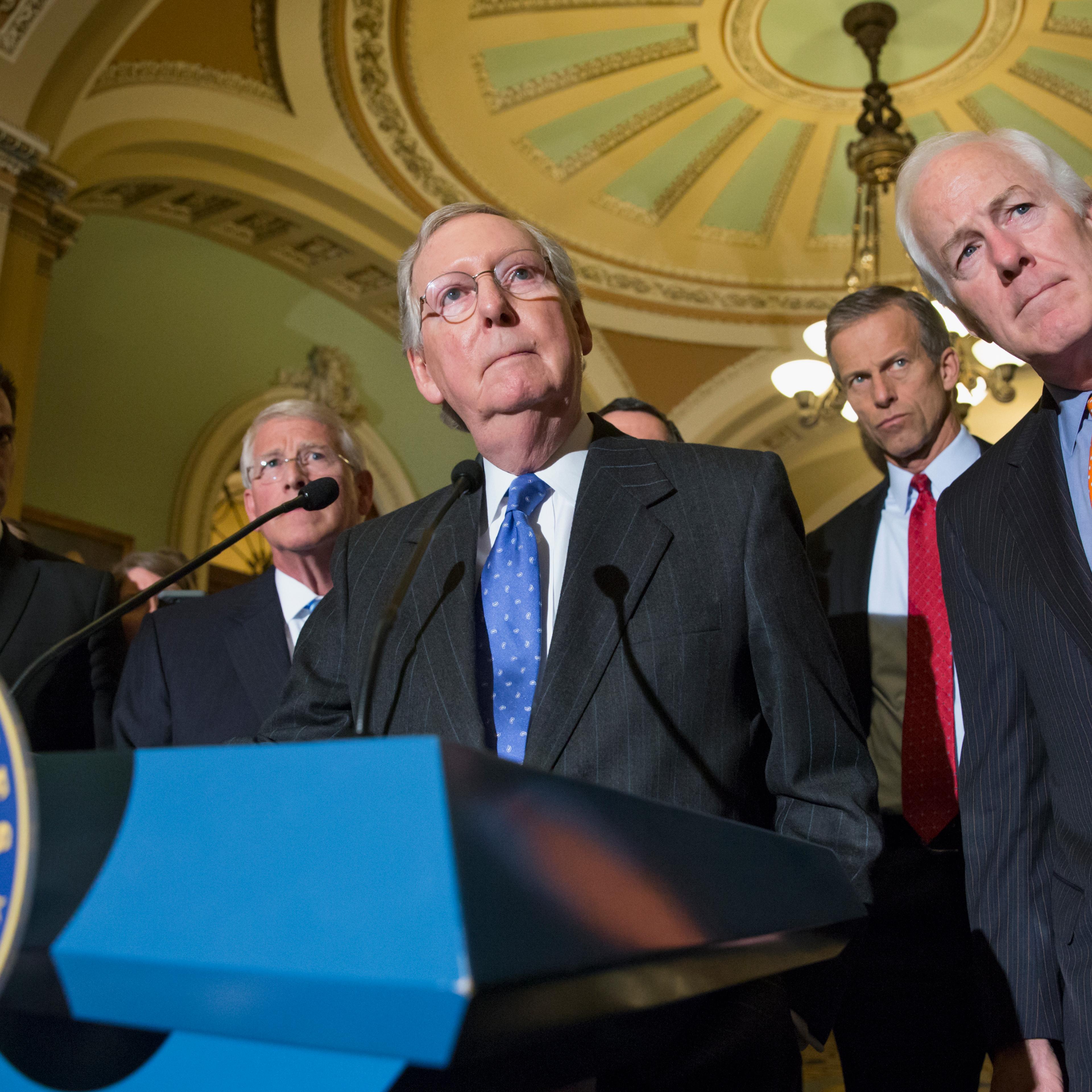 Mitch McConnell, center, speaks with reporters on Capitol Hill in Washington, D.C. on Feb. 23, 2016.