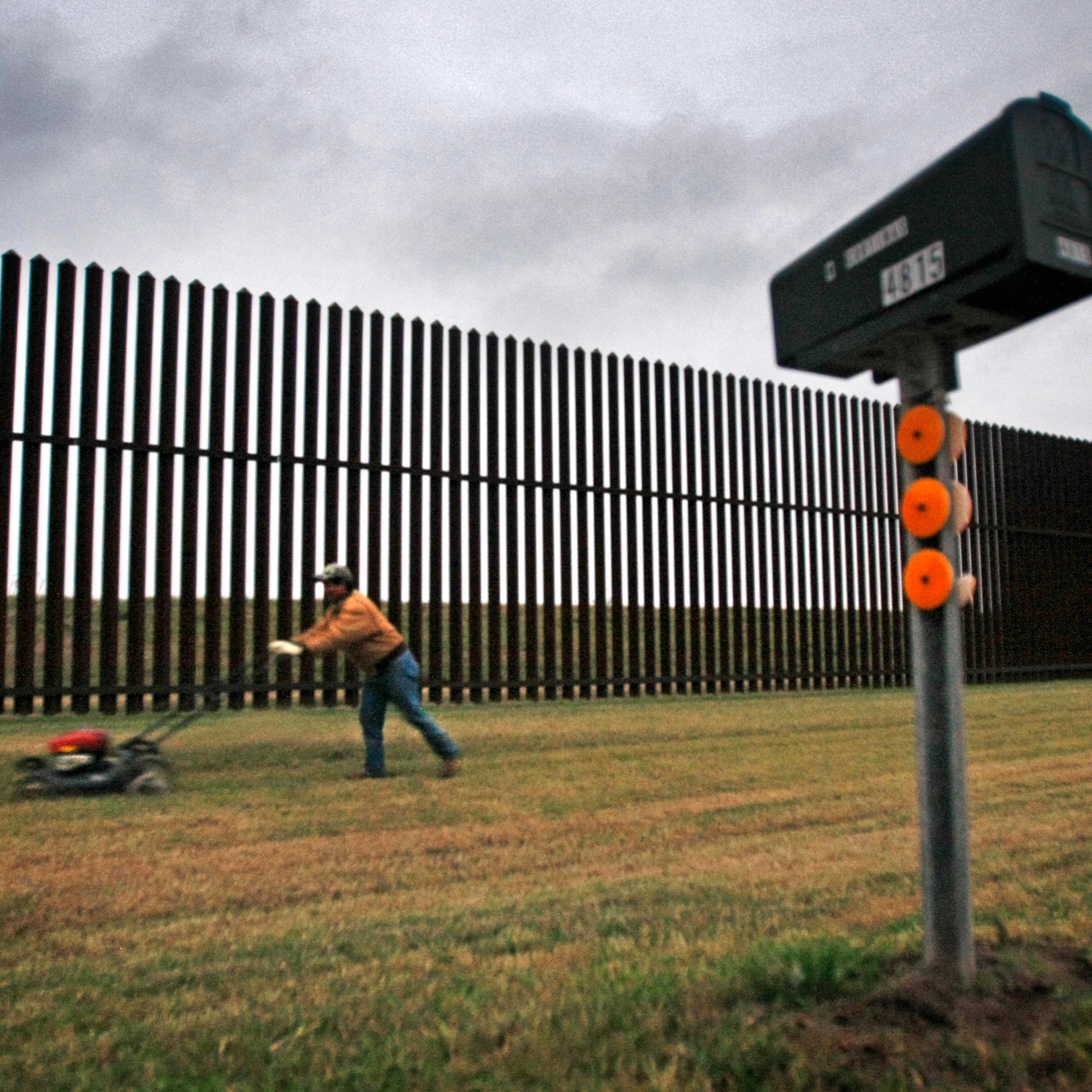 JANUARY 20, 2011. BROWNSVILLE, TEXAS. A resident on Oklahoma Avenue outside Brownsville, Texas mows