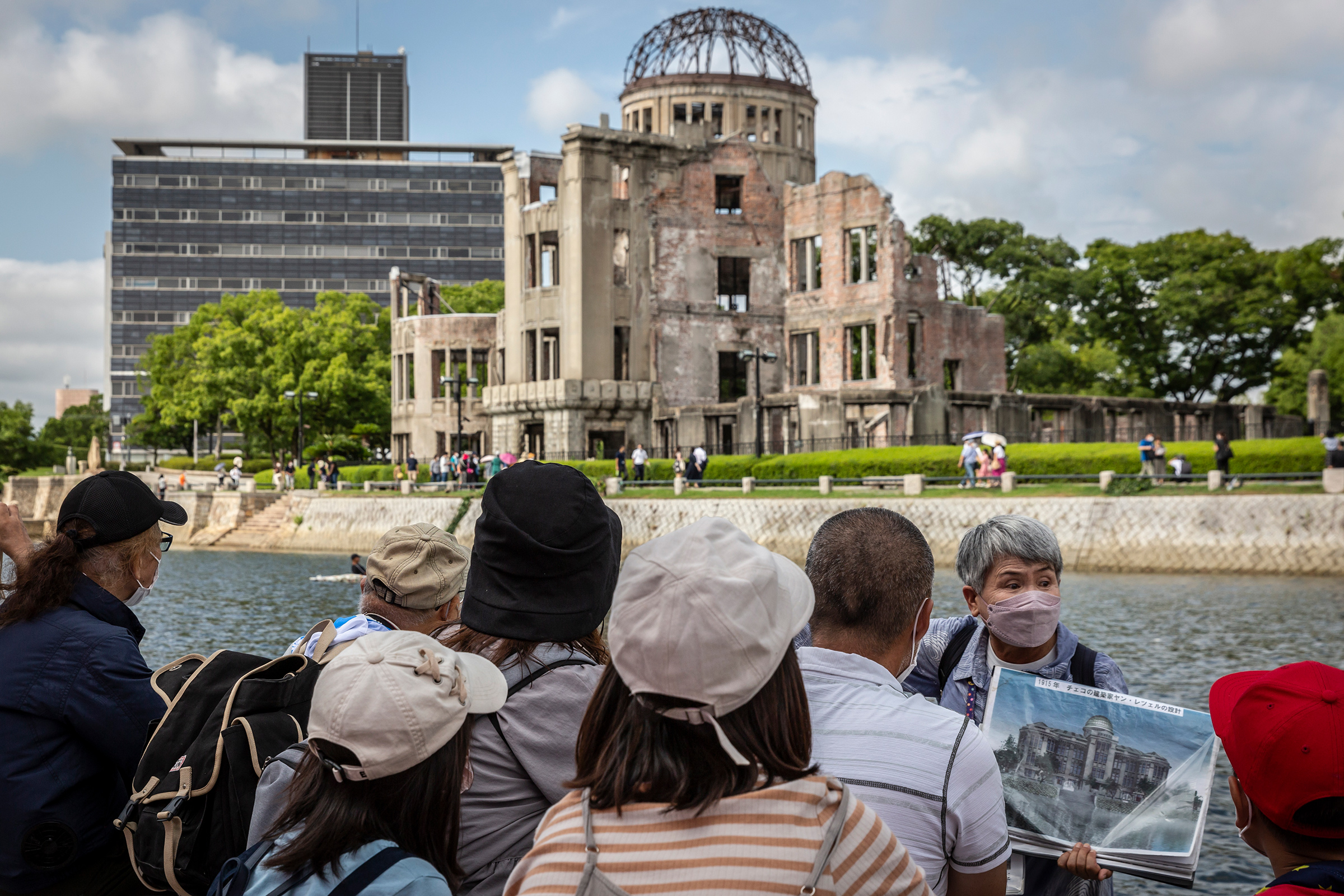 A volunteer guide explains the history of the Atomic Bomb Dome in Hiroshima’s Peace Memorial Park on Aug. 05, 2022.