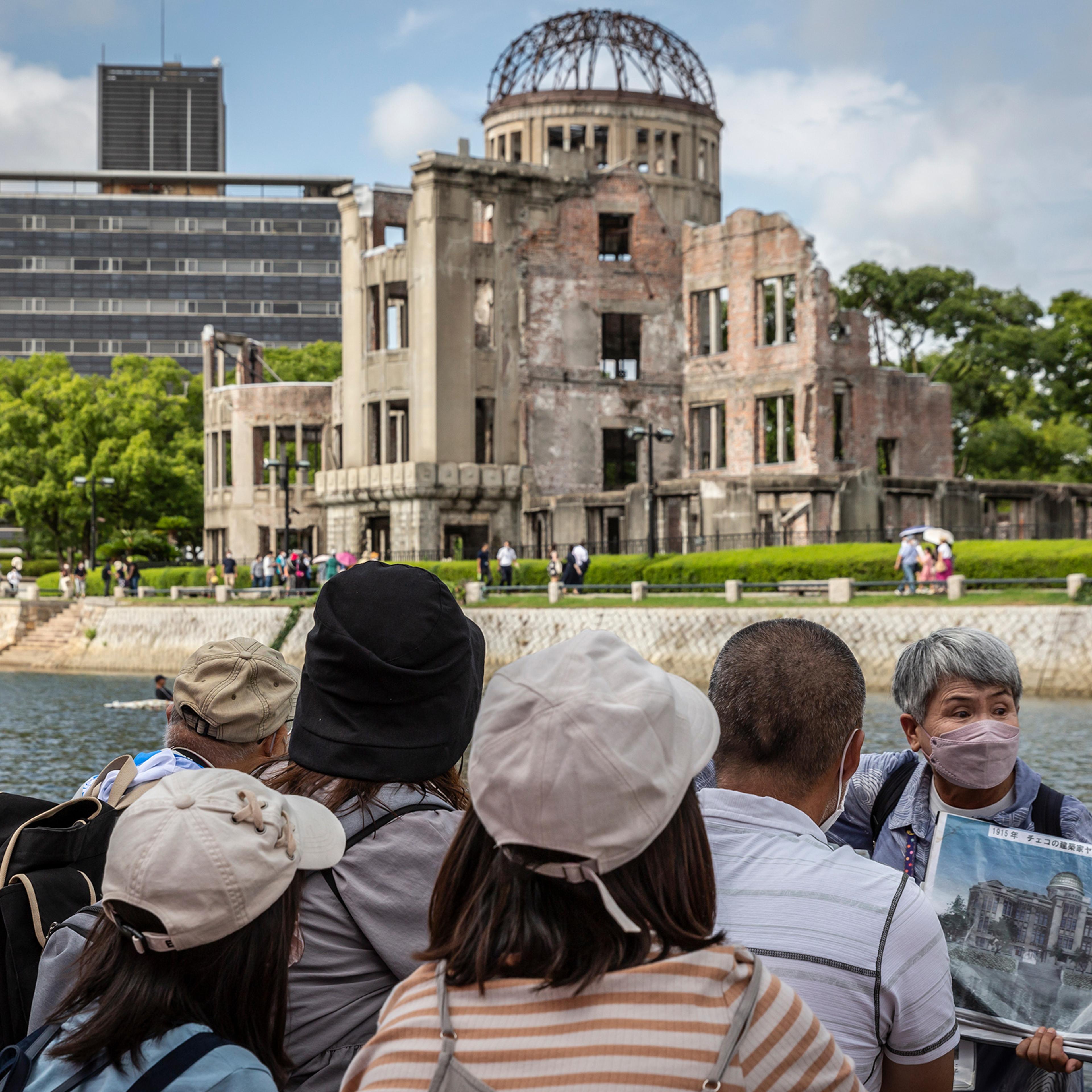 A volunteer guide explains the history of the Atomic Bomb Dome in Hiroshima’s Peace Memorial Park on Aug. 05, 2022.