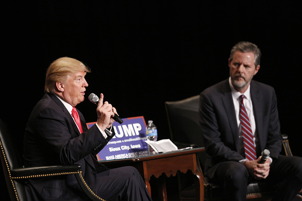 Donald Trump, president and chief executive of Trump Organization Inc. and 2016 Republican presidential candidate, left, speaks as Jerry Falwell Jr., president of Liberty University, listens during a campaign event at the Orpheum Theater in Sioux City, I