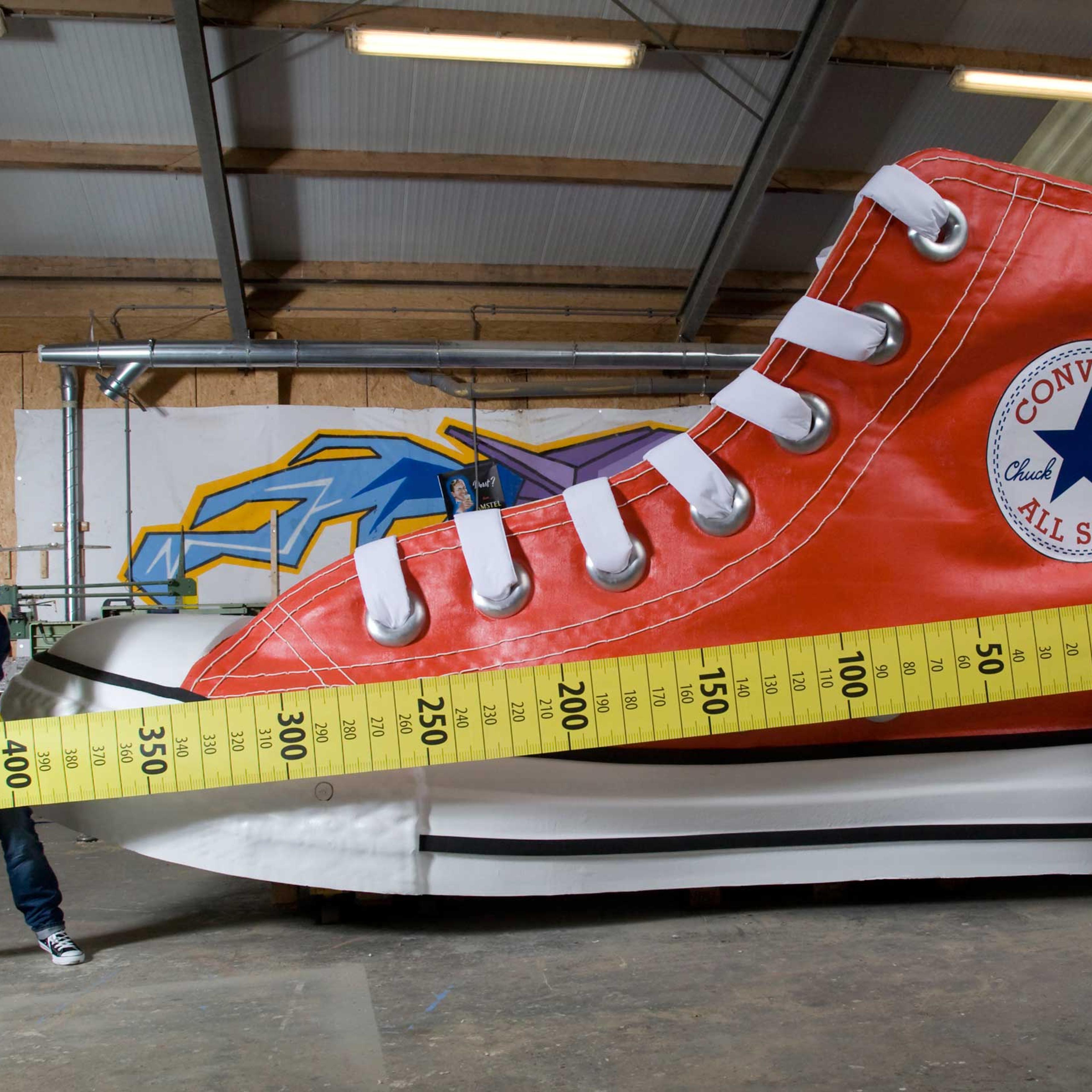 Largest ShoeAttempt Text The largest shoe measures 5.50 m (18 ft 0.53 in) x 2.11 m (6 ft 11.07 in) and is 2.90 m (9 ft 6.17 in) high and was unveiled by the Nationaal Fonds Kinderhulp (Netherlands) in Amsterdam, the Netherlands, on 17 November 2010, in c
