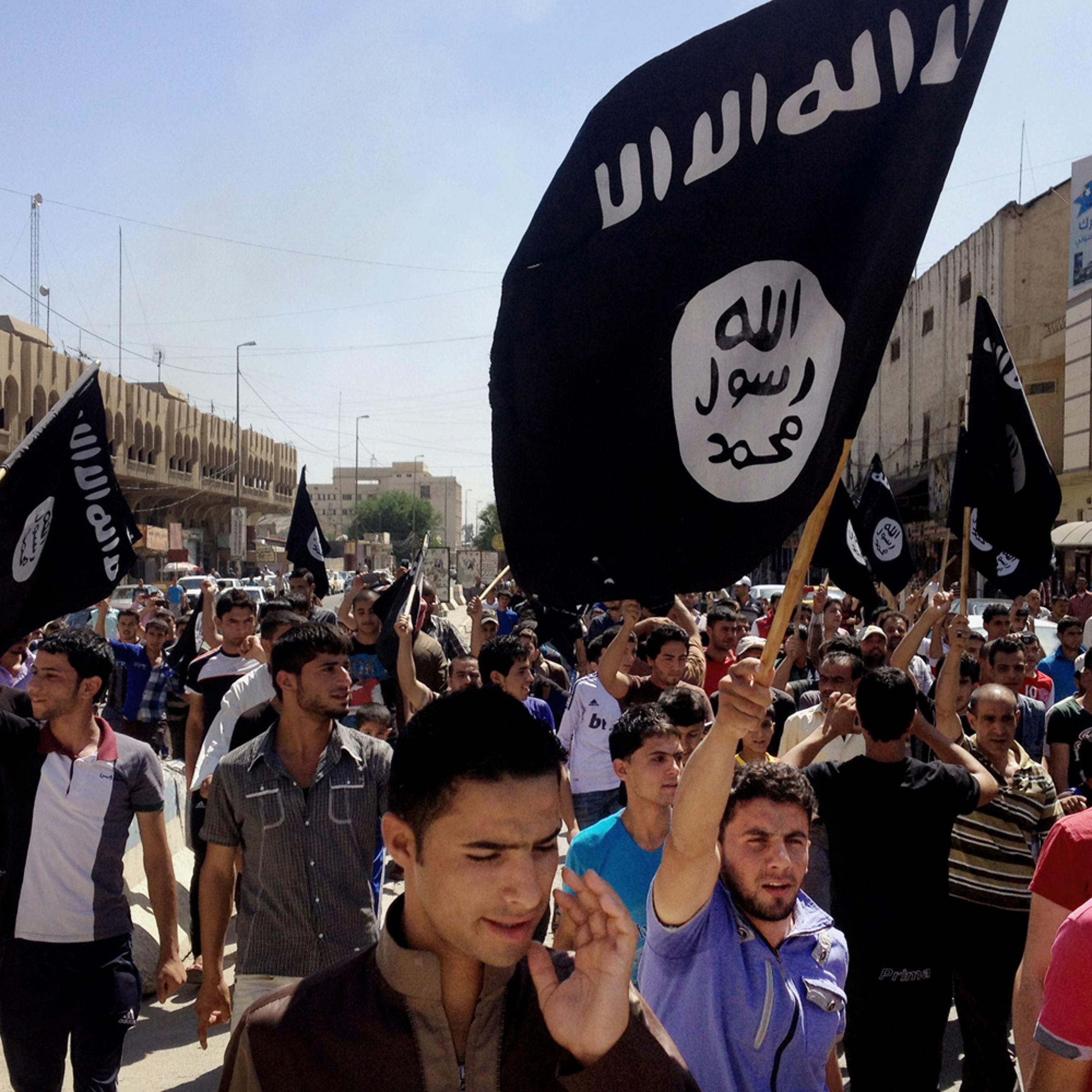 Demonstrators chant pro-al-Qaida-inspired Islamic State of Iraq and Syria (ISIS) as they carry al-Qaida flags in front of the provincial government headquarters in Mosul, June 16.